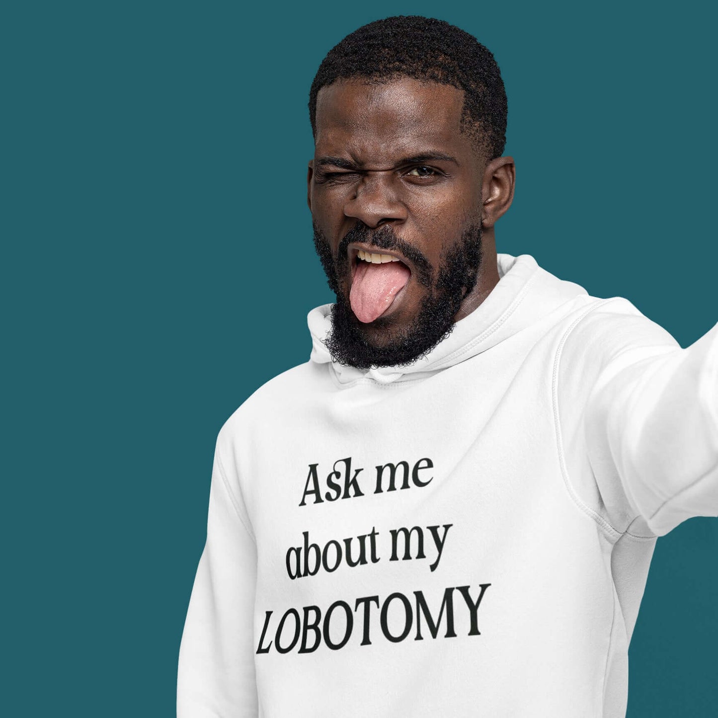 Man making funny face wearing a white hoodie with the phrase Ask me about my lobotomy printed on the front.