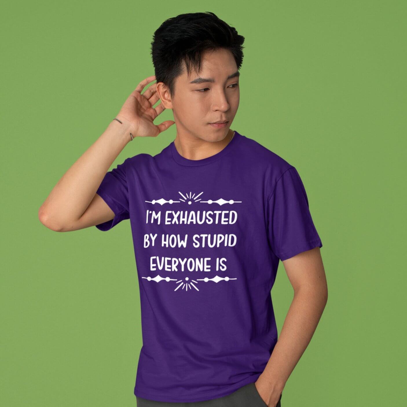 Man wearing a purple t-shirt with the phrase Im exhausted by how stupid everyone is printed on the front.