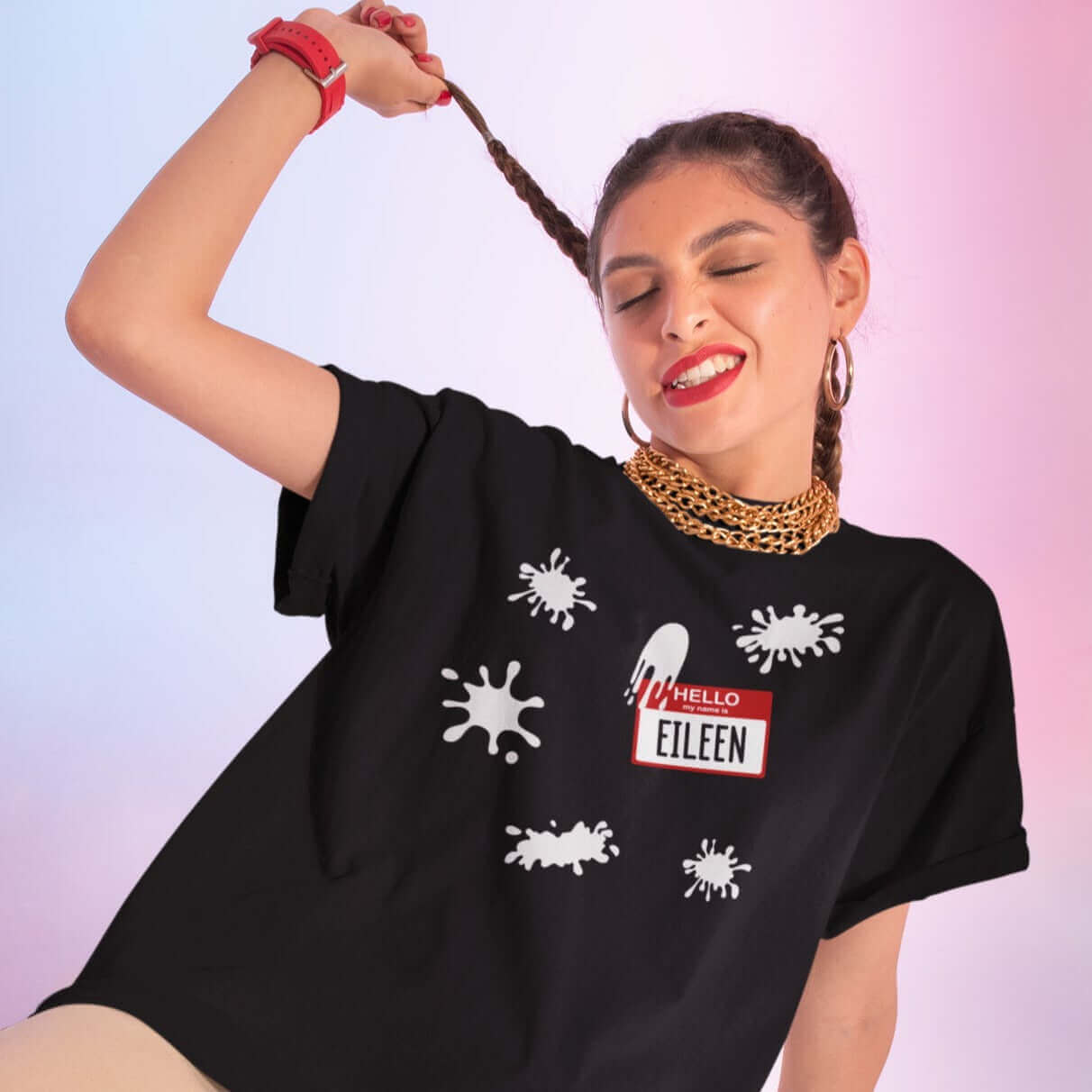 Woman wearing black t-shirt with Eileen name tag and white splatters printed on the front.