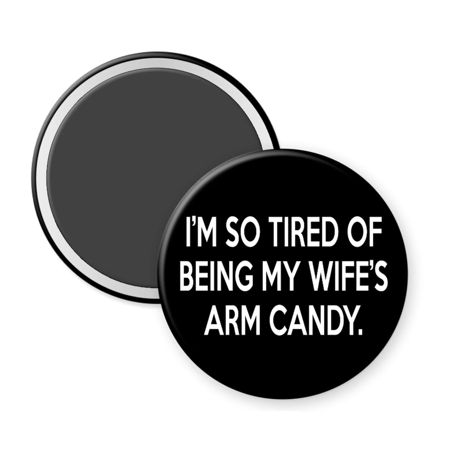 Round black magnet with white text on a white background
