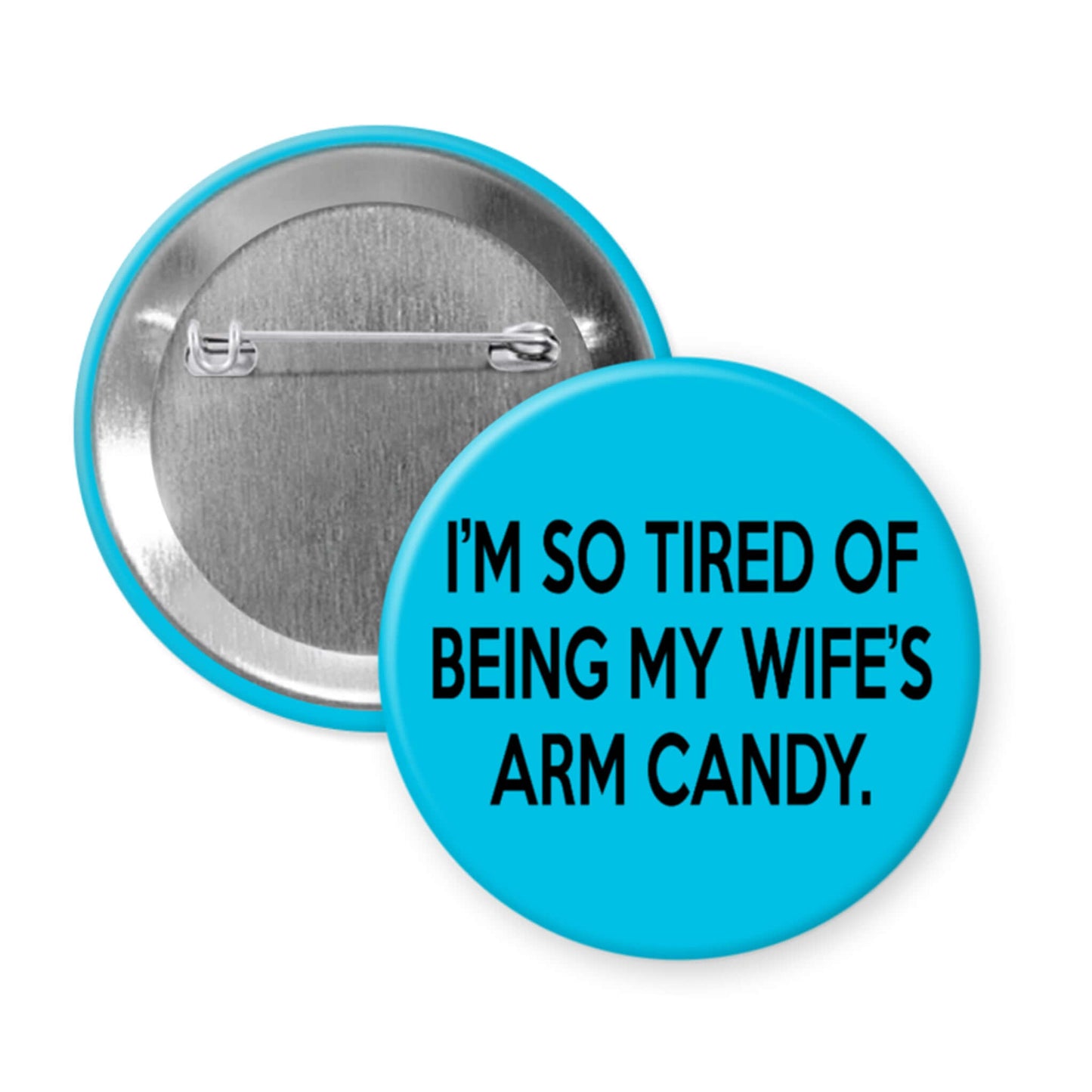 Button badge with text 'I'm so tired of being my wife's arm candy' on a blue background