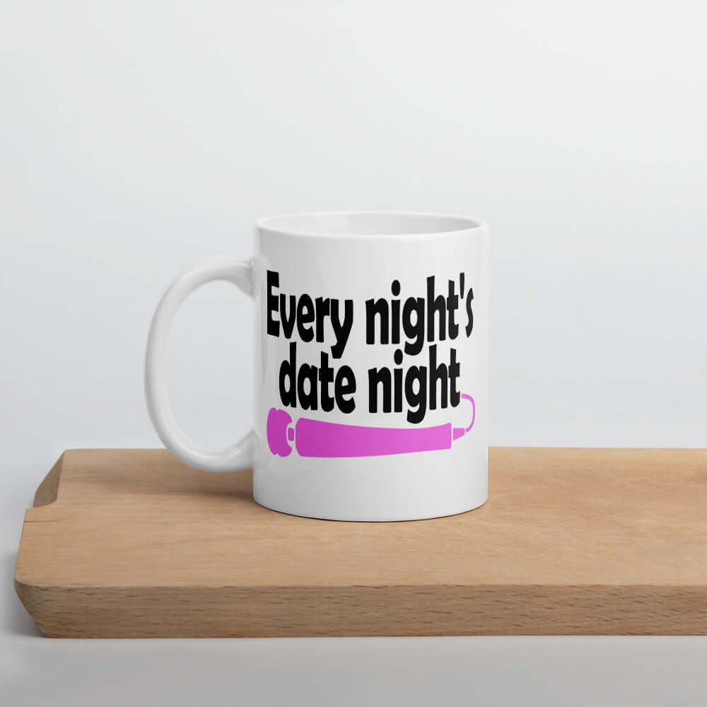 White ceramic coffee mug with the phrase Every night is date night with a hot pink wand vibrator printed beneath. The graphics are printed on both sides of the mug.