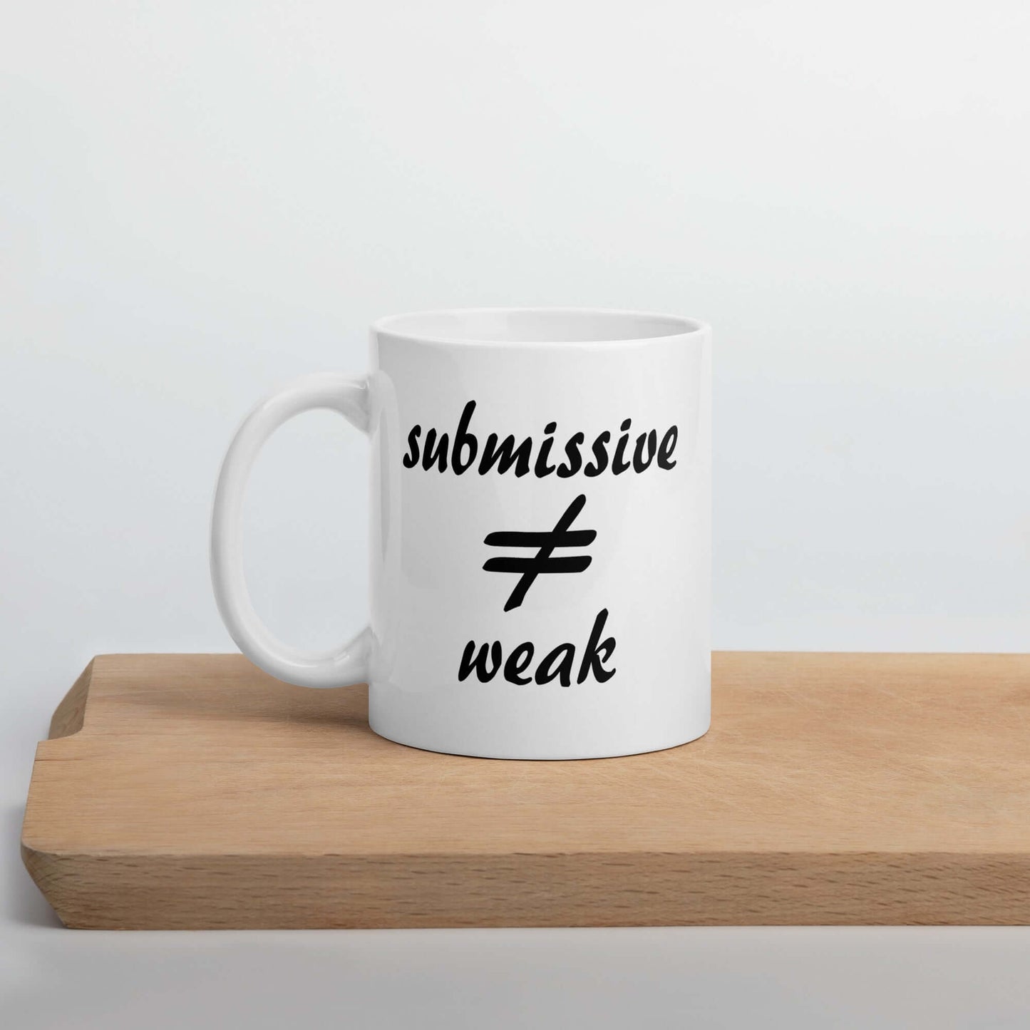 White ceramic coffee mug with the words submissive does not equal weak printed on both sides.