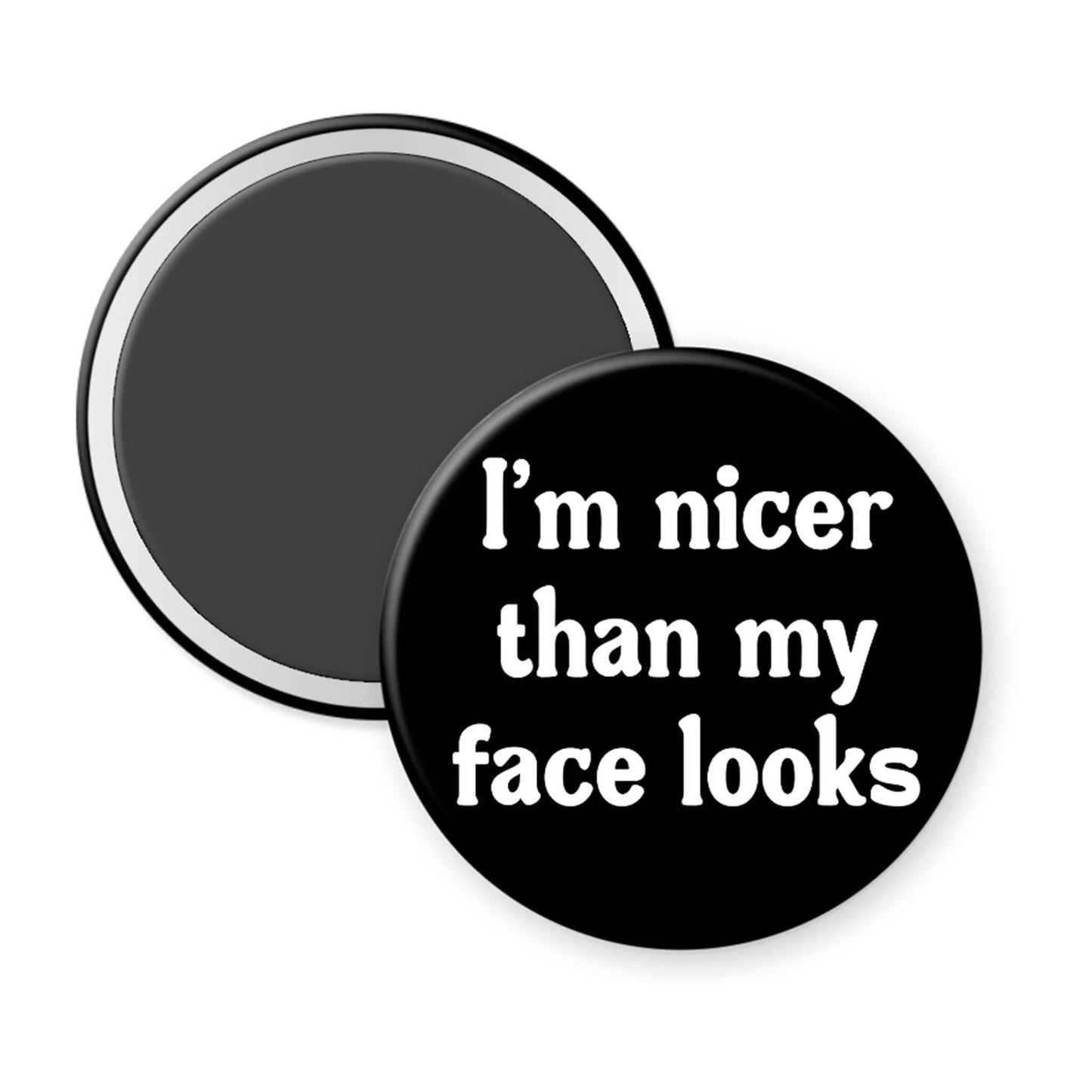 Round black magnet with white text 'I'm nicer than my face looks' on a white background