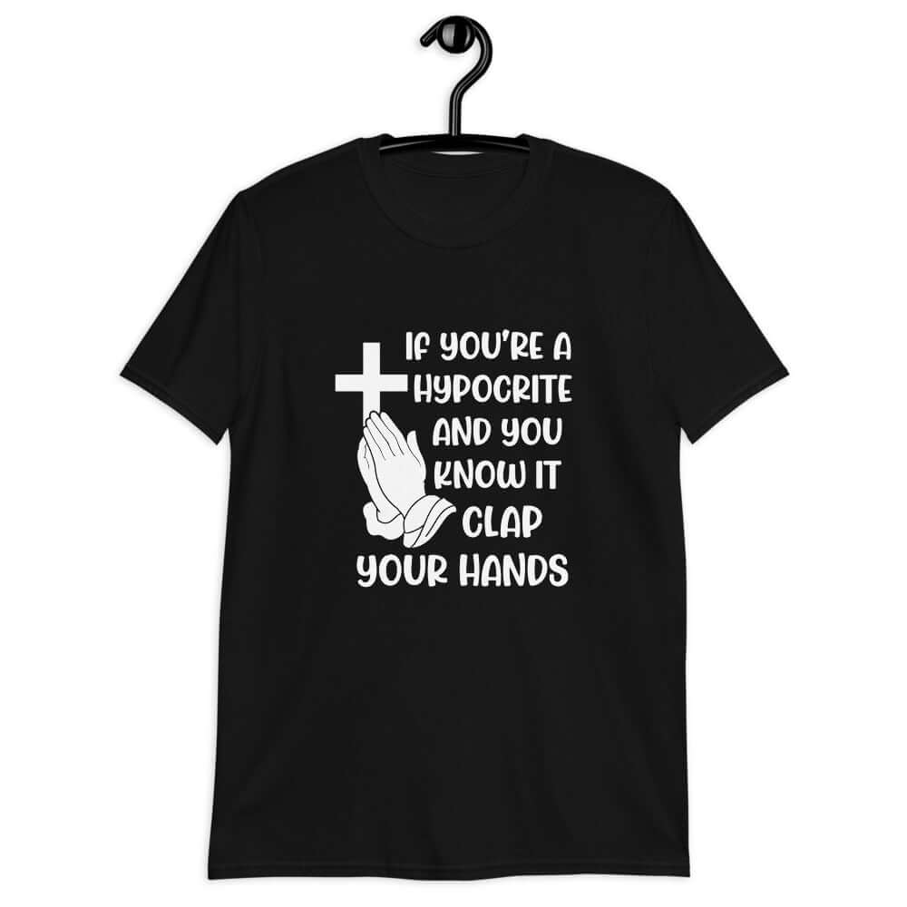 Black t-shirt with image of a cross and praying hands & the words If you're a hypocrite and you know it clap your hands printed on the front.