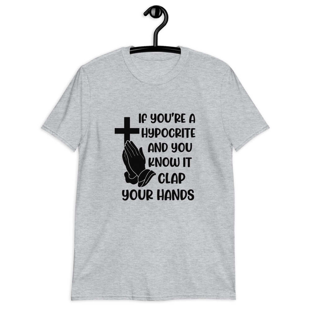 Light sport grey t-shirt with image of a cross and praying hands & the words If you're a hypocrite and you know it clap your hands printed on the front.