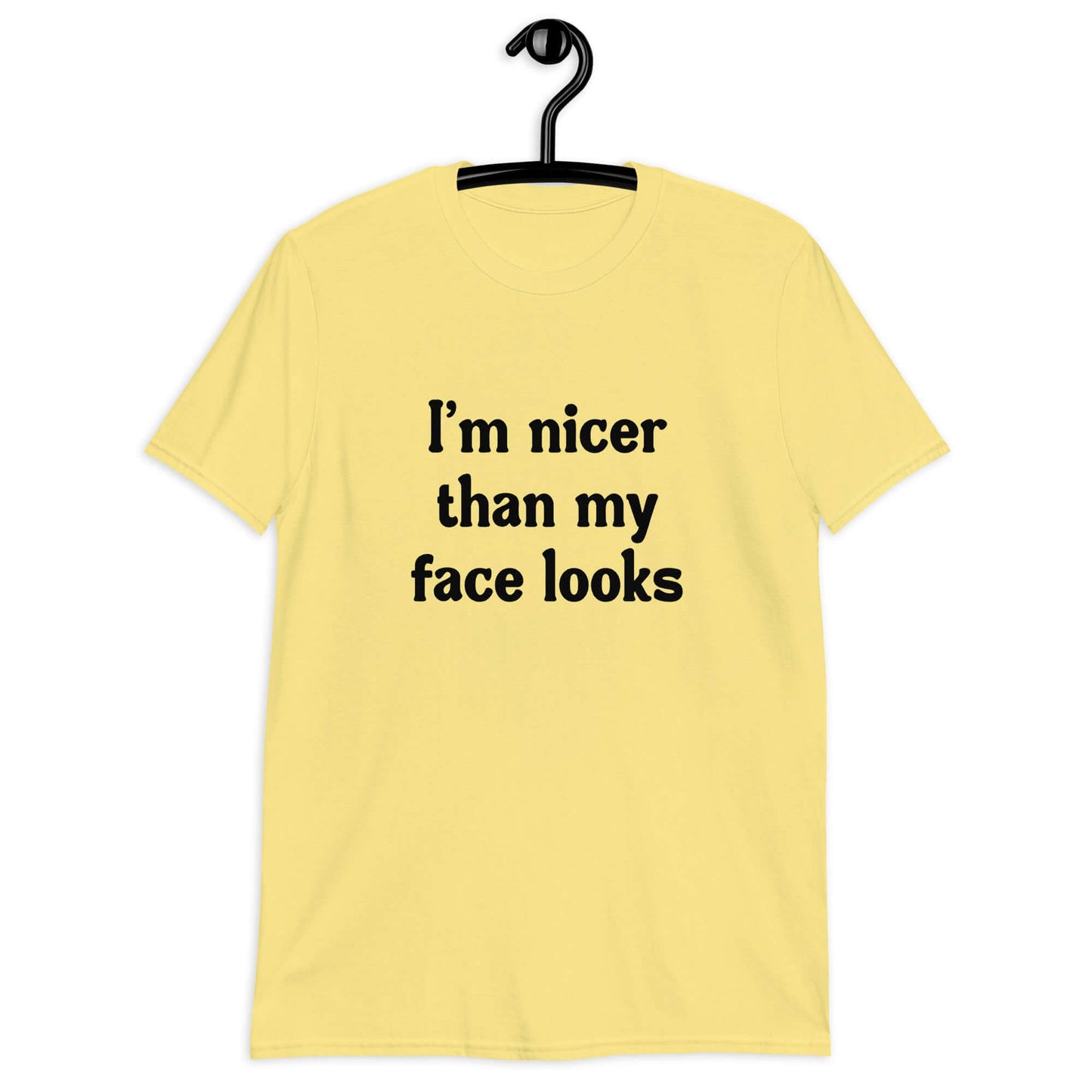 Cornsilk yellow t-shirt with the phrase I'm nicer than my face looks printed on the front.