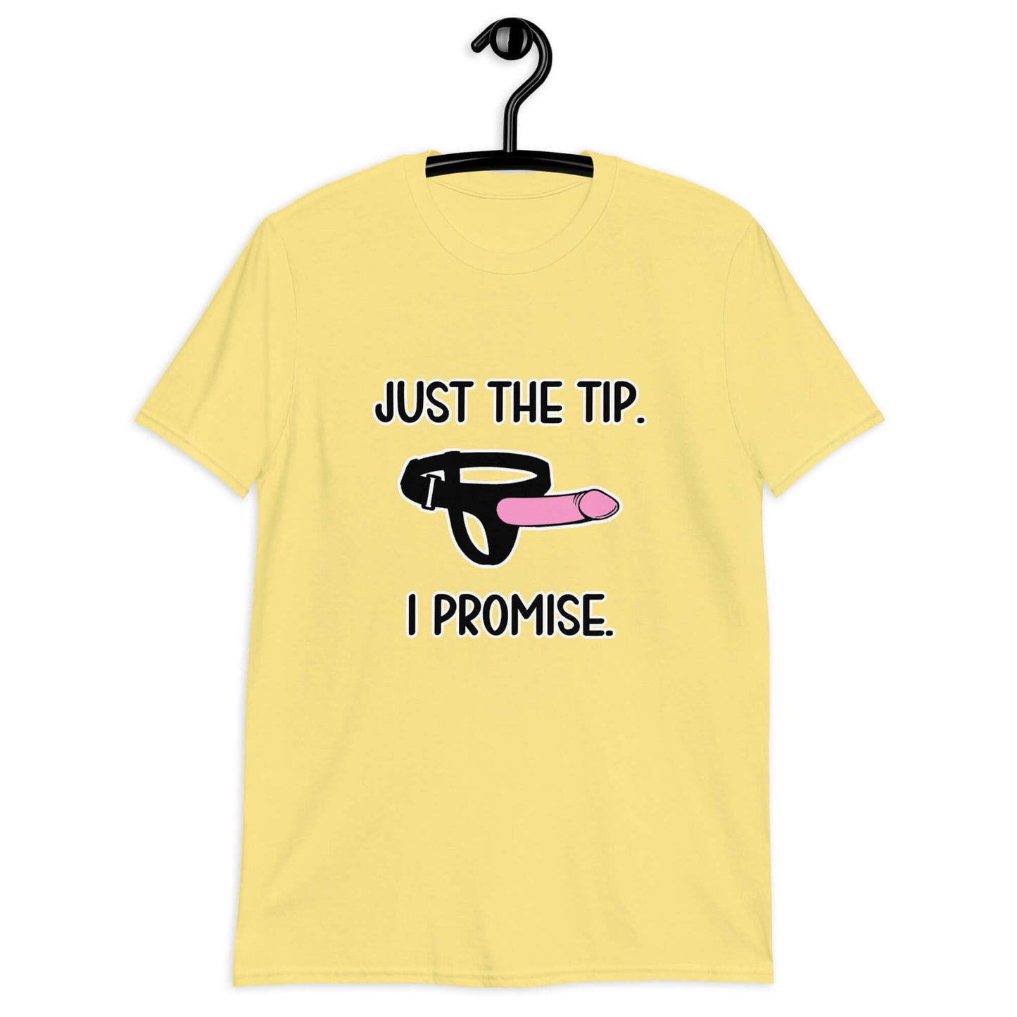 Cornsilk yellow t-shirt that has an image of a strap-on dildo and the words Just the tip, I promise printed on the front. The graphics are pink, black and white.