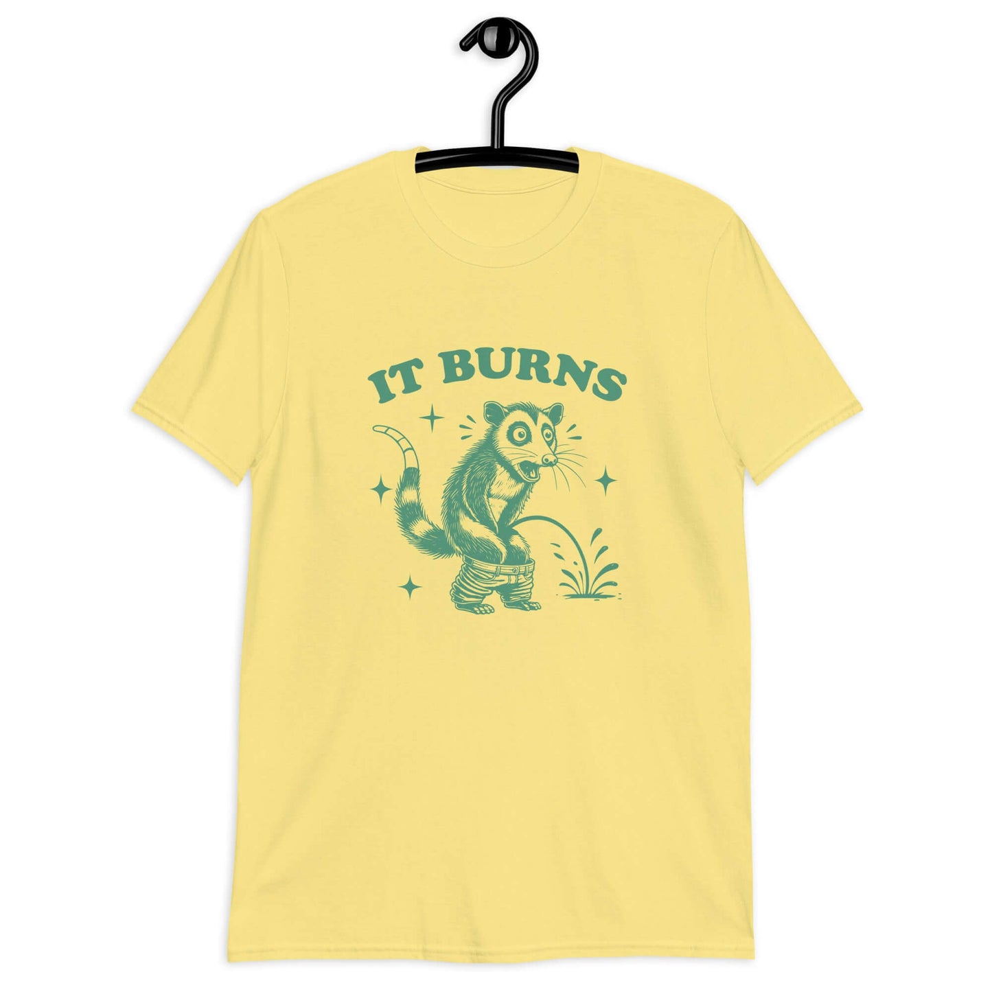 Cornsilk yellow t-shirt with an image of an opossum peeing. The words It burns are printed above.