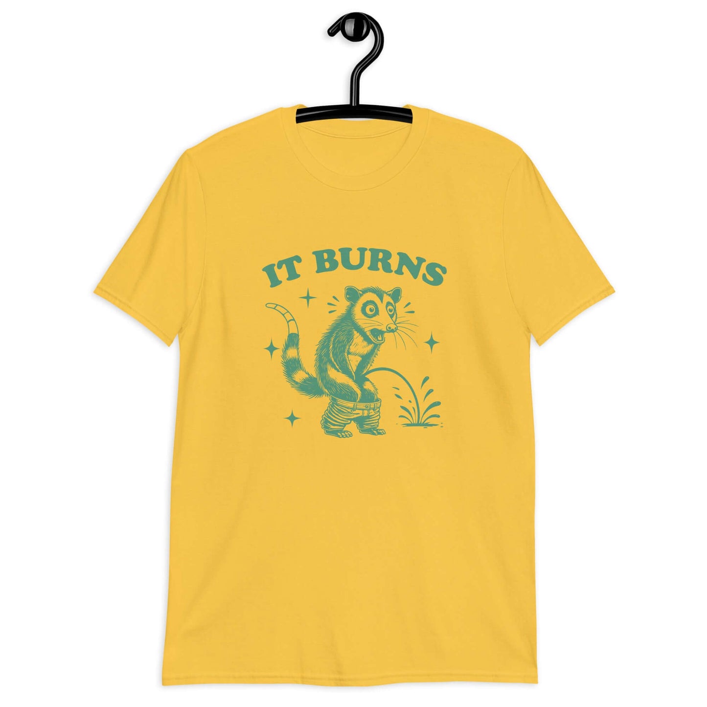 Daisy yellow t-shirt with an image of an opossum peeing. The words It burns are printed above.
