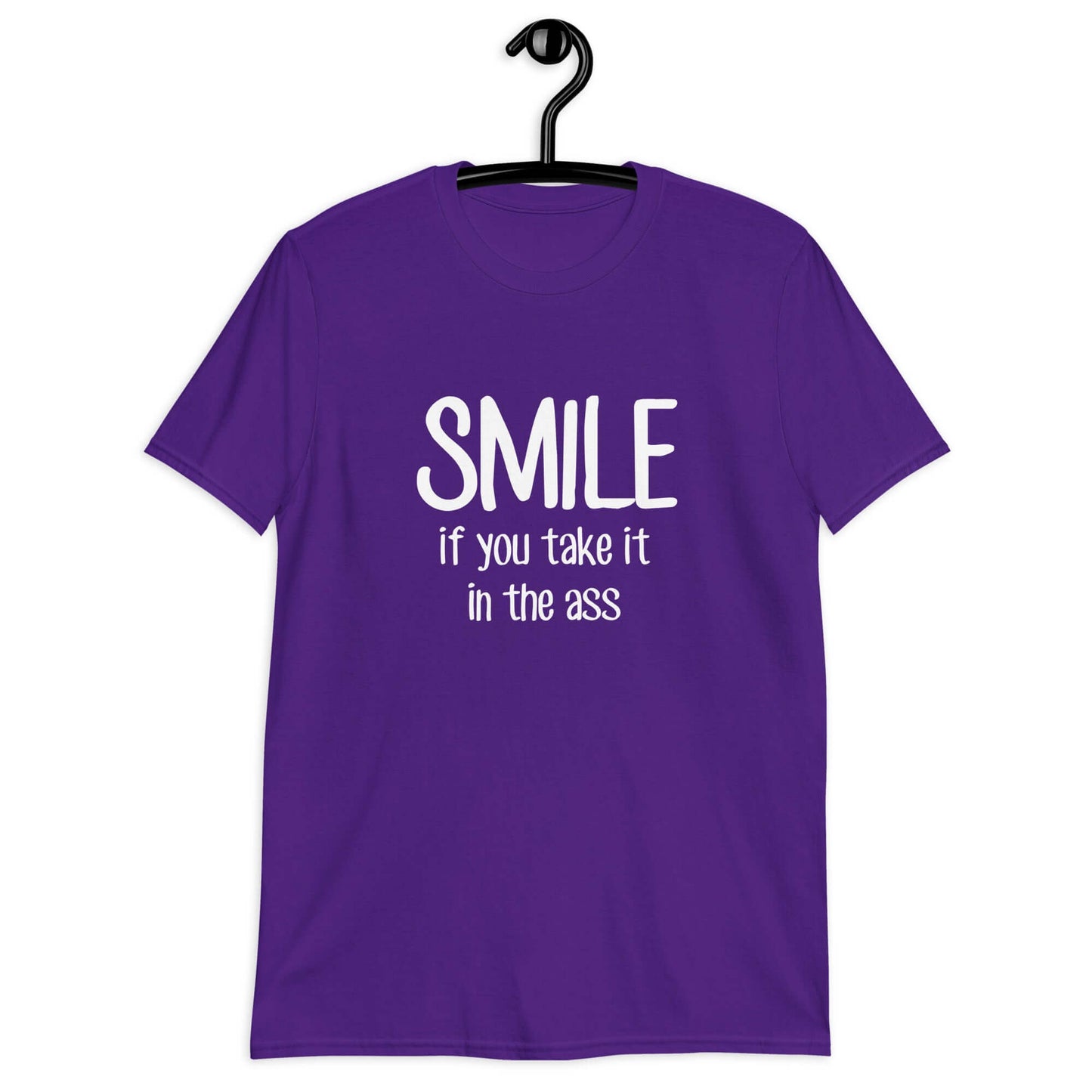 Purple t-shirt with the phrase Smile if you take it in the ass printed on the front. The word smile is large and the words take it in the ass are much smaller.