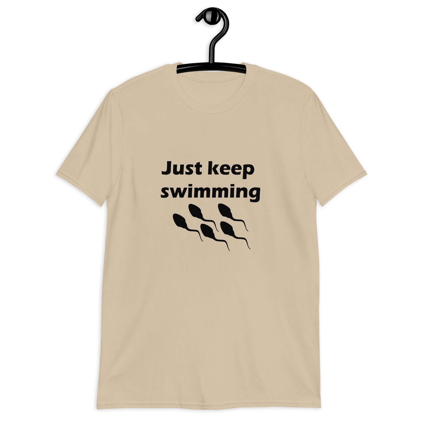 Sand t-shirt with the phrase Just keep swimming printed on the front. There is an image of some swimming sperm underneath the words.