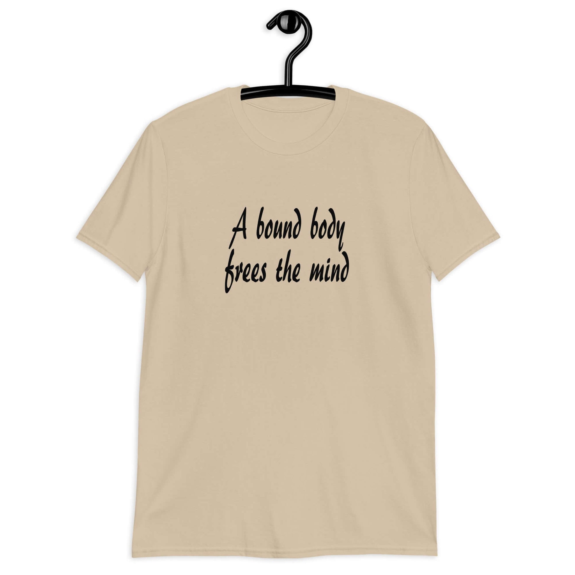 Sand color t-shirt with the phrase A bound body frees the mind printed on the front.