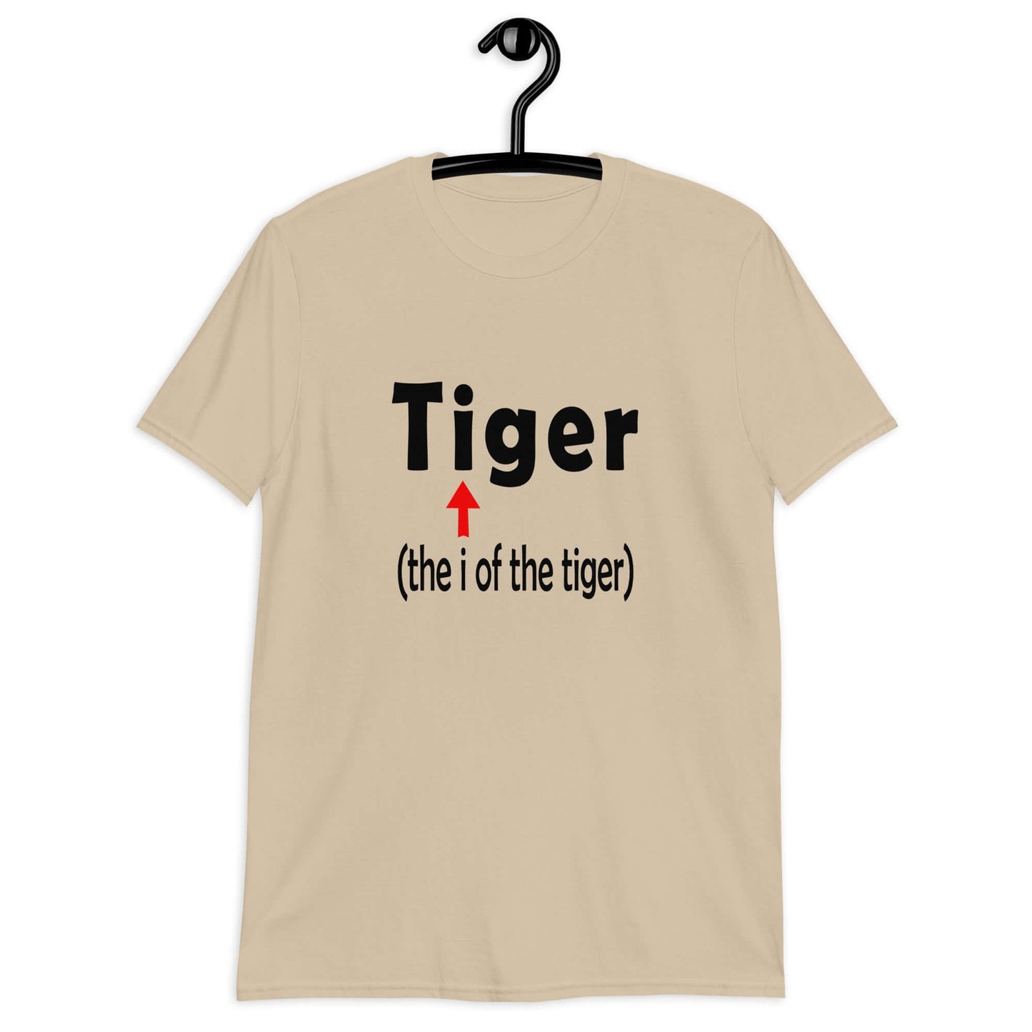 Sand color t-shirt with the word Tiger and in smaller letters it says the I of the tiger with an arrow pointing to the letting I in the word tiger. The graphics are printed on the front of the shirt.