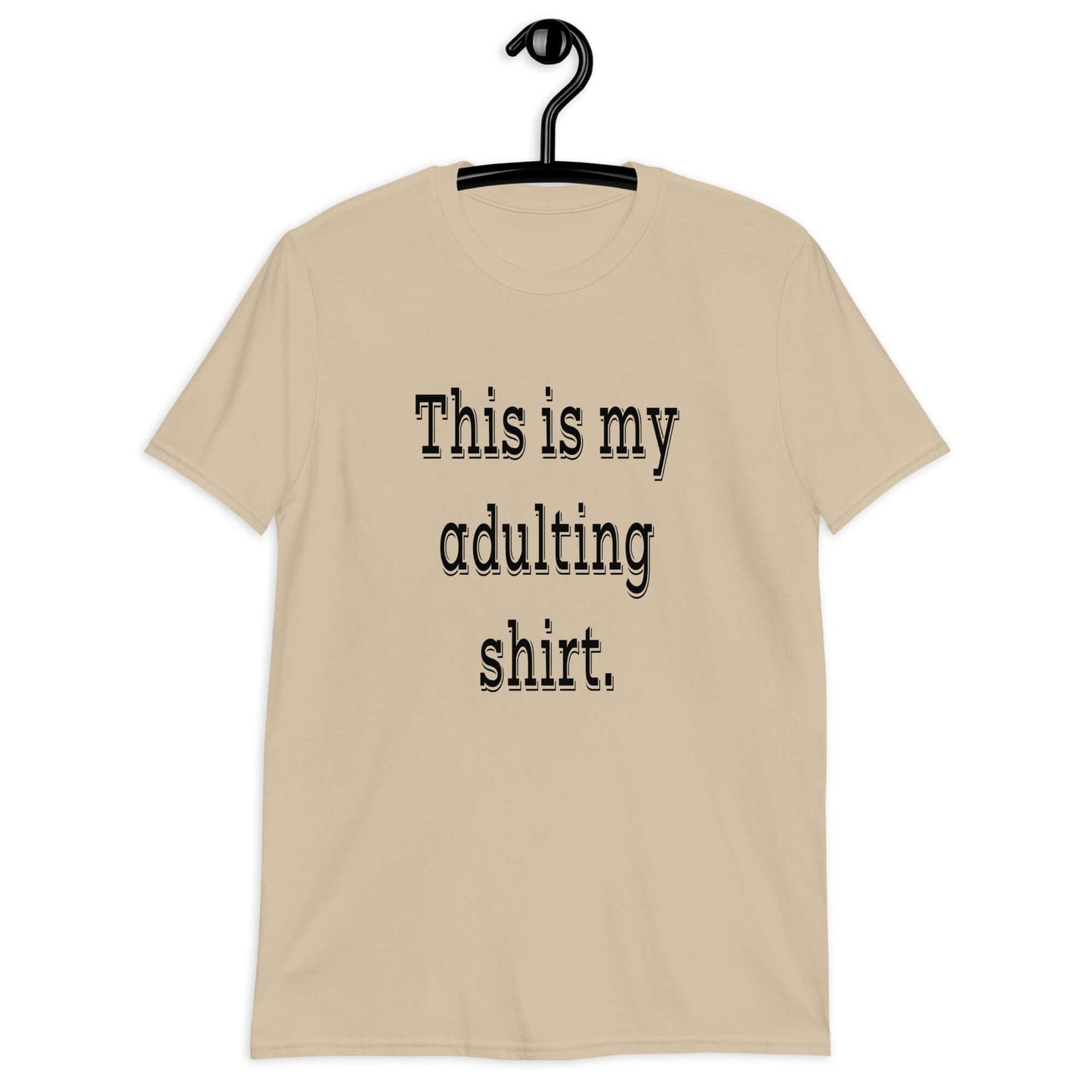 Sand color t-shirt with the phrase This is my adulting shirt printed on the front.
