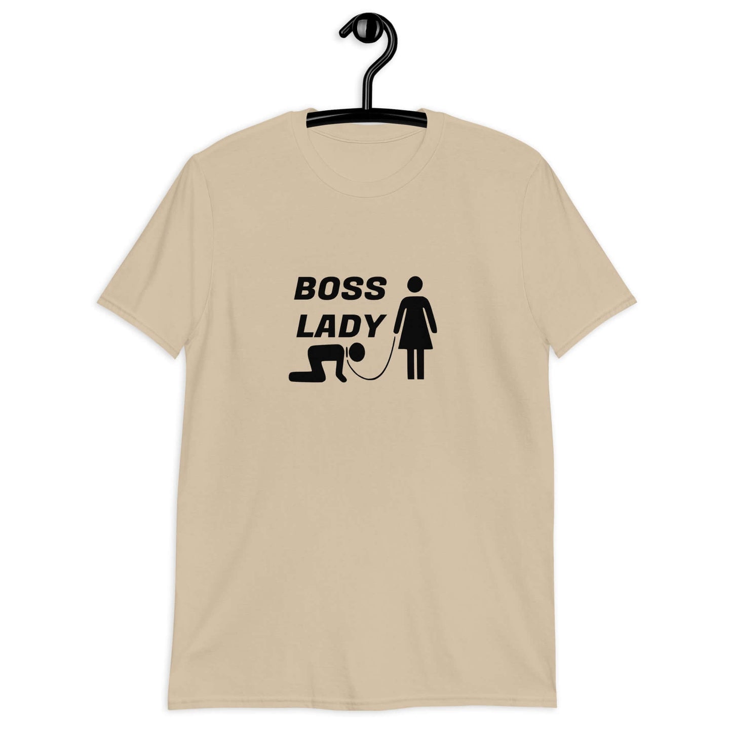 Sand color t-shirt with graphic of collared and leashed man on his hands and knees being led by a woman and the words Boss lady above. The graphics are printed on the front of the shirt.