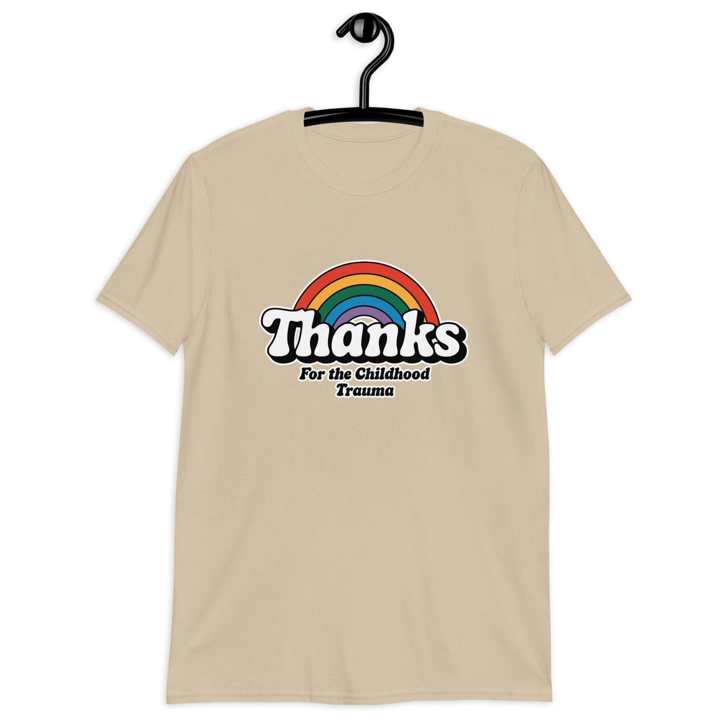 Sand t-shirt with an image of a rainbow and the words Thanks for the childhood trauma printed on the front. The word Thanks is large and the rest of the words are smaller under.