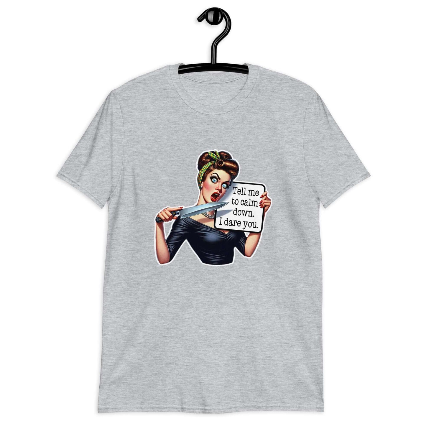Sport grey t-shirt displayed on a hanger. The t-shirt has a graphic of an angry looking retro woman holding a knife and a sign. The sign says Tell me to calm down I dare you. The graphic is printed on the front of the shirt.