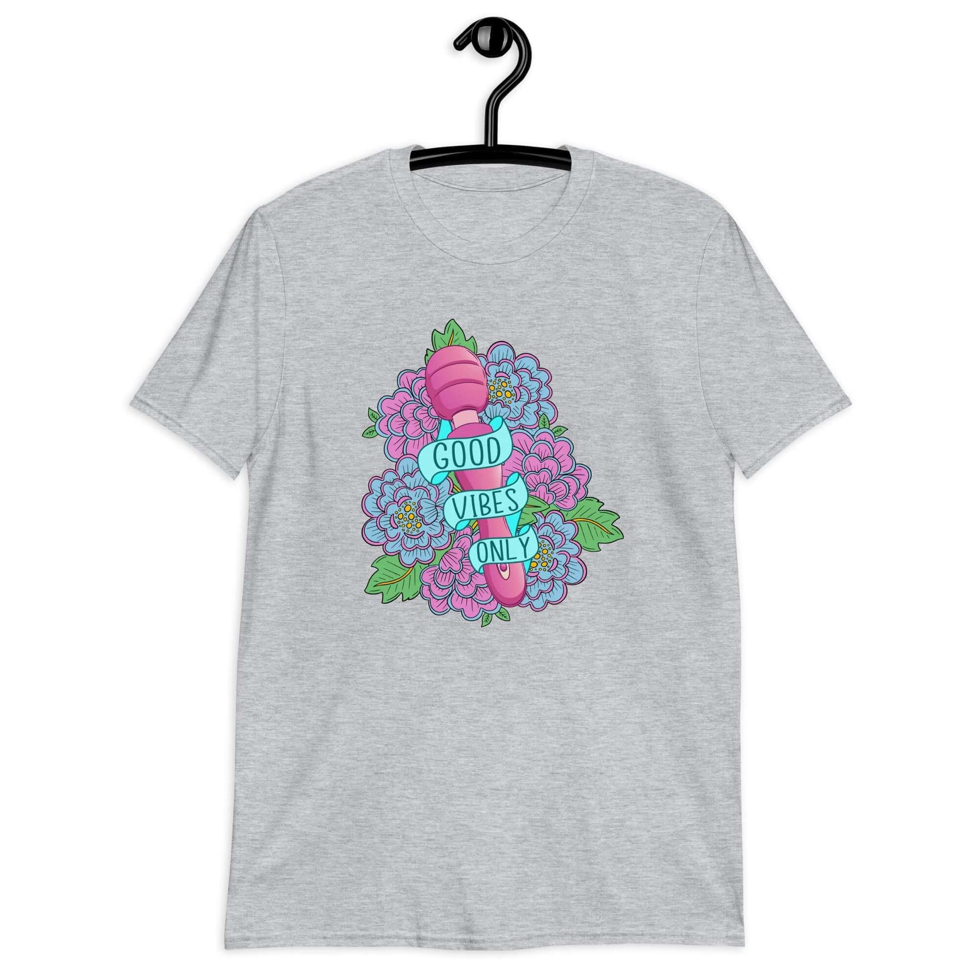Sport grey t-shirt with graphic design that has the words Good vibes only layered over a pink wand vibrator with flowers around. The graphic design is printed on the front of the shirt.