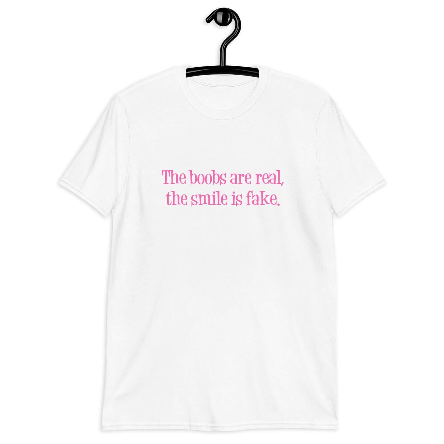 White t-shirt with the phrase The boobs are real, the smile is fake printed in pink on the front.