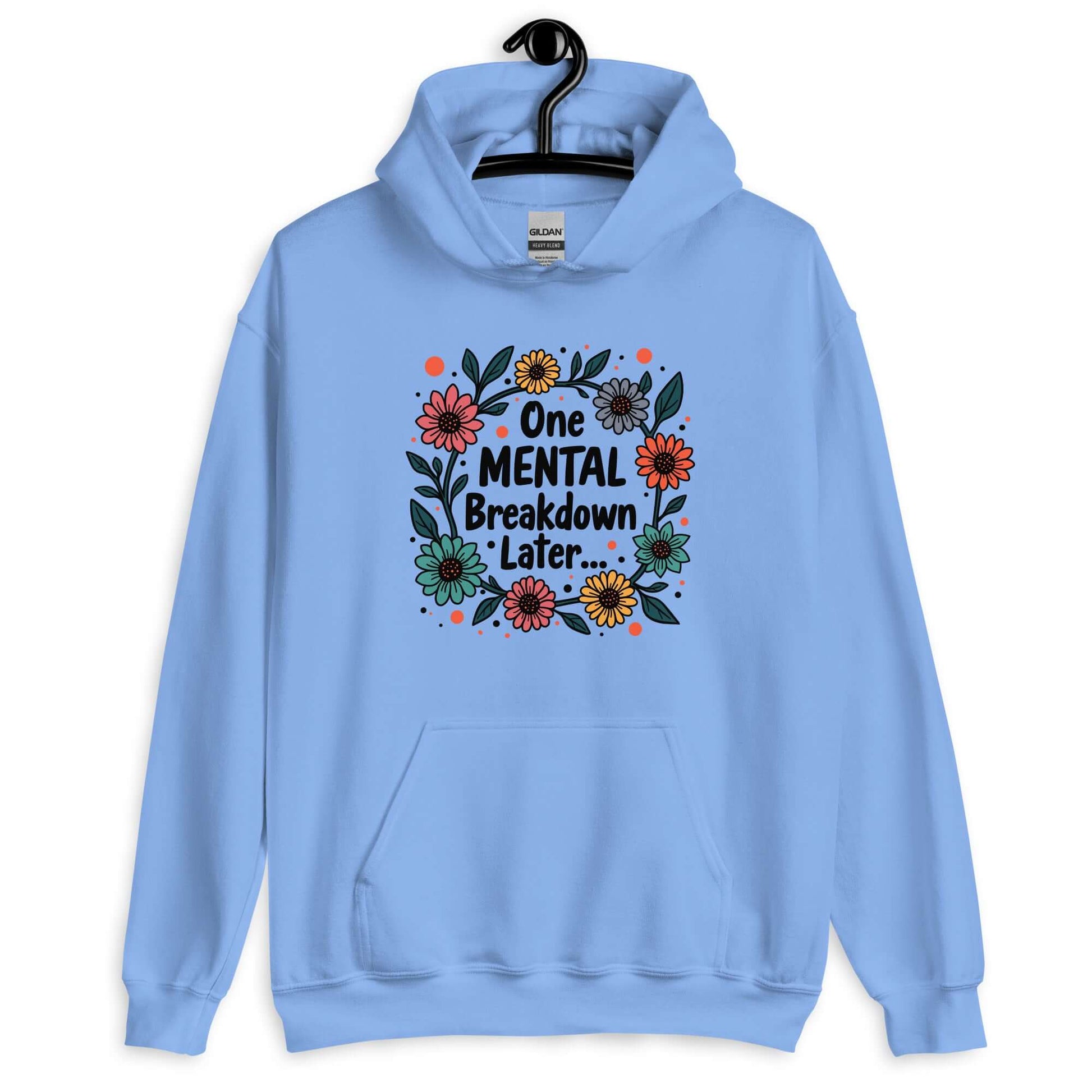 Carolina blue hoodie sweatshirt with a multi color floral wreath design printed on the front. The words One mental breakdown later are printed in the center of the wreath.