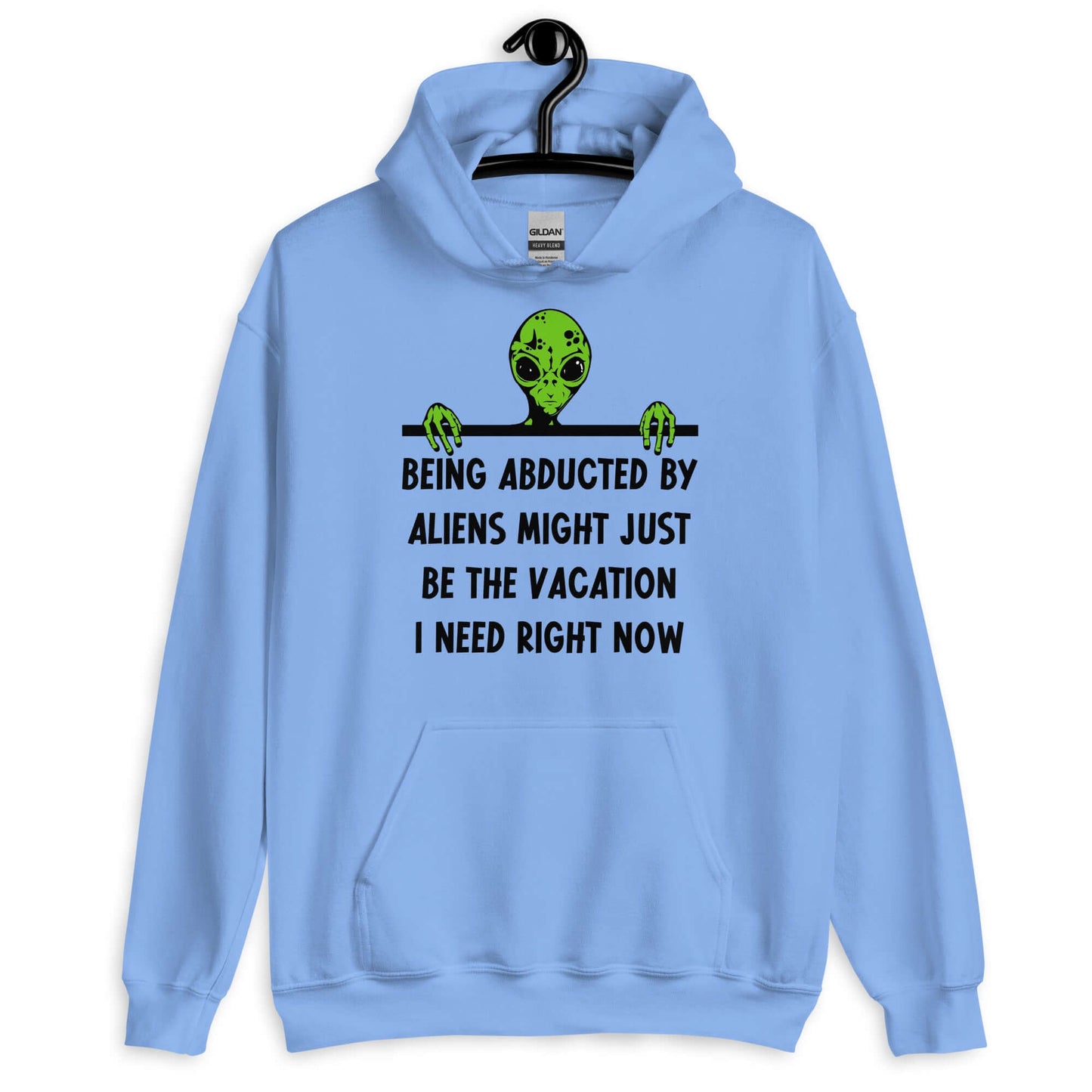 Carolina blue hoodie with an image of a green alien and the phrase Being abducted by aliens might just be the vacation I need right now printed on the front of the sweatshirt.