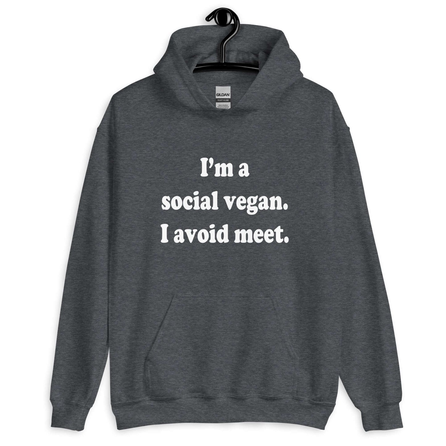 Dark heather grey hoodie sweatshirt with the pun phrase I'm a social vegan, I avoid meet printed on the front.