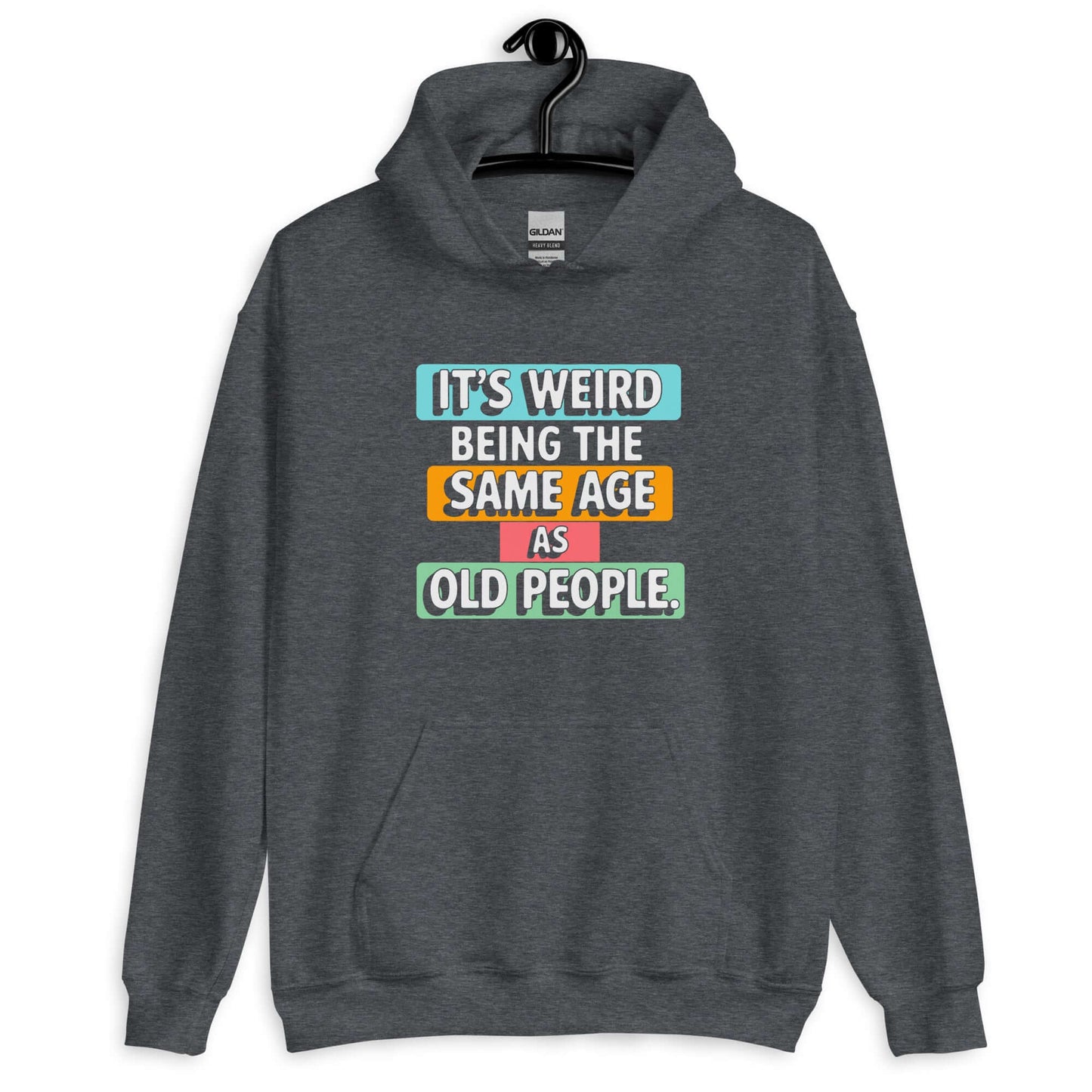 Dark heather grey hoodie sweatshirt with colorful graphics that say It's weird being the same age as old people printed on the front.