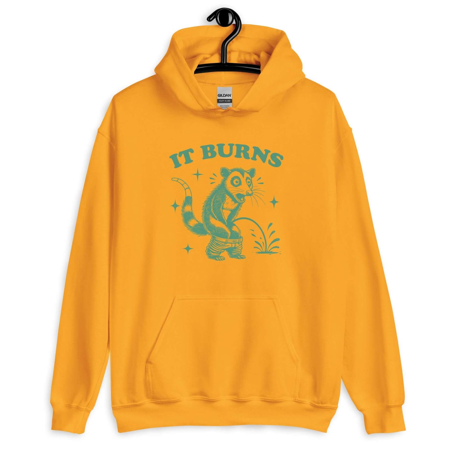 Golden yellow hoodie sweatshirt with an image of an opossum peeing. The words It burns are printed above.