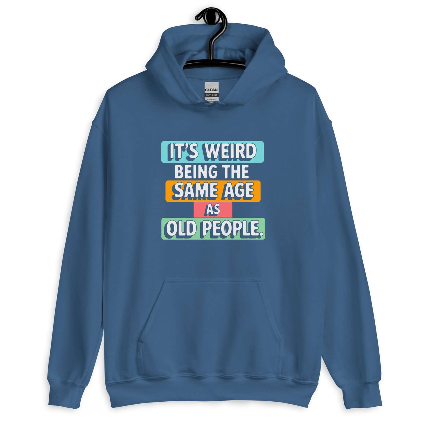 Indigo blue hoodie sweatshirt with colorful graphics that say It's weird being the same age as old people printed on the front.