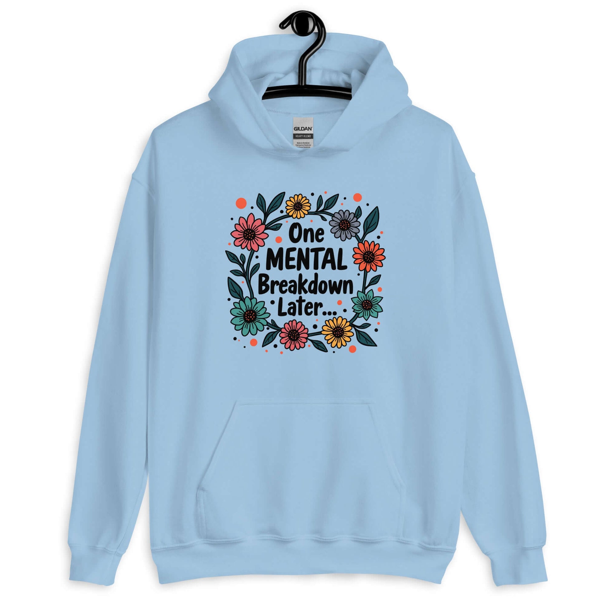 Light blue hoodie sweatshirt with a multi color floral wreath design printed on the front. The words One mental breakdown later are printed in the center of the wreath.