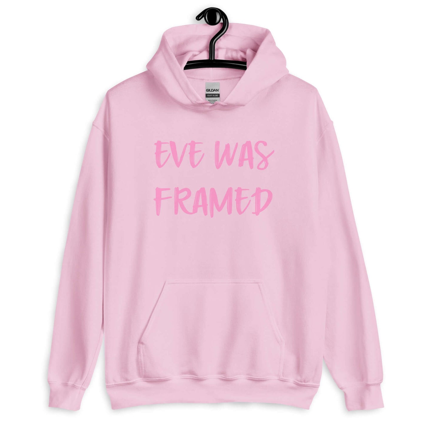 Light pink hoodie sweatshirt with the words Eve was framed printed on the front in slightly darker pink.