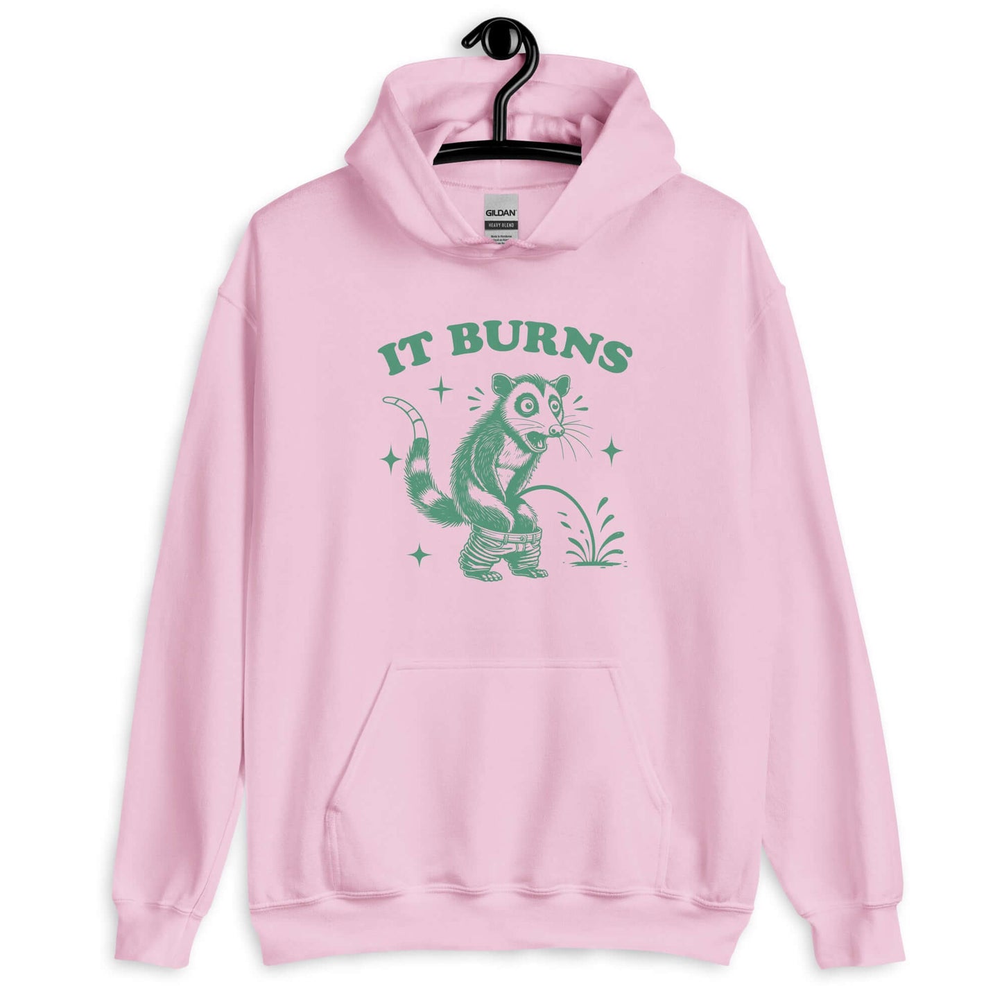 Light pink hoodie sweatshirt with an image of an opossum peeing. The words It burns are printed above.