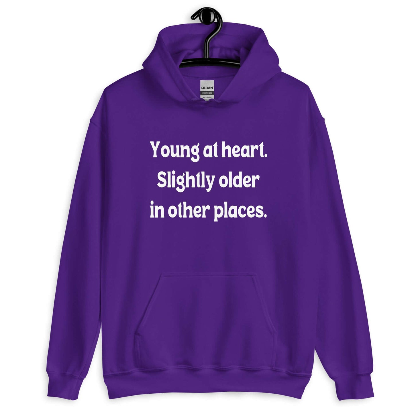 Purple hoodie sweatshirt with the words Young at heart, slightly older in other places printed on the front.