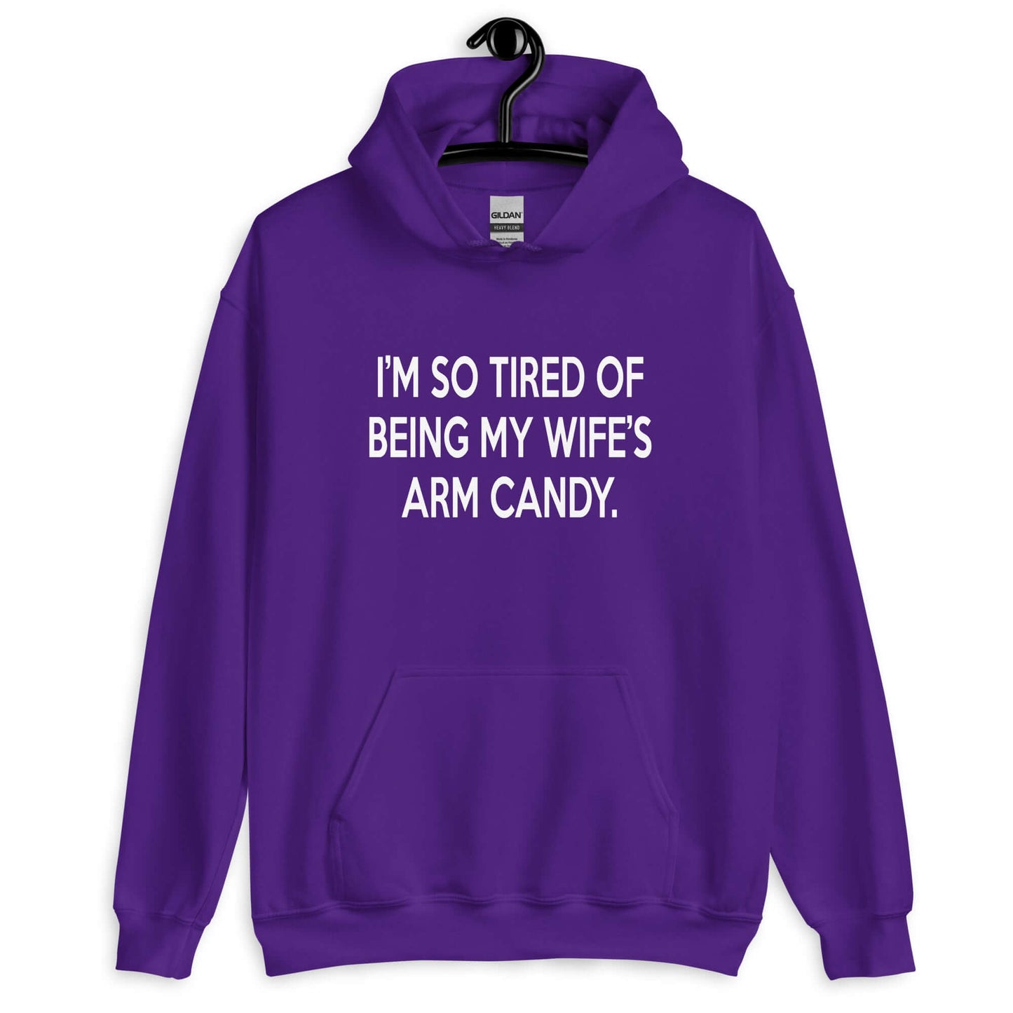 Purple hoodie sweatshirt with the funny phrase I'm so tired of being my wife's arm candy printed on the front.