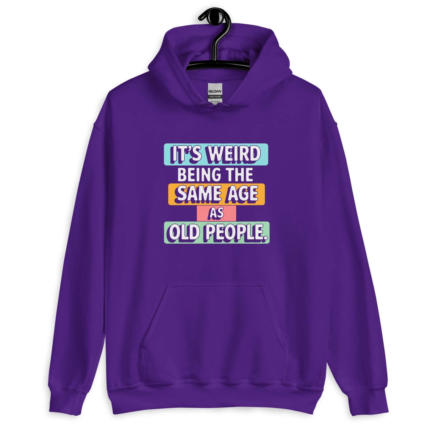 Purple hoodie sweatshirt with colorful graphics that say It's weird being the same age as old people printed on the front.