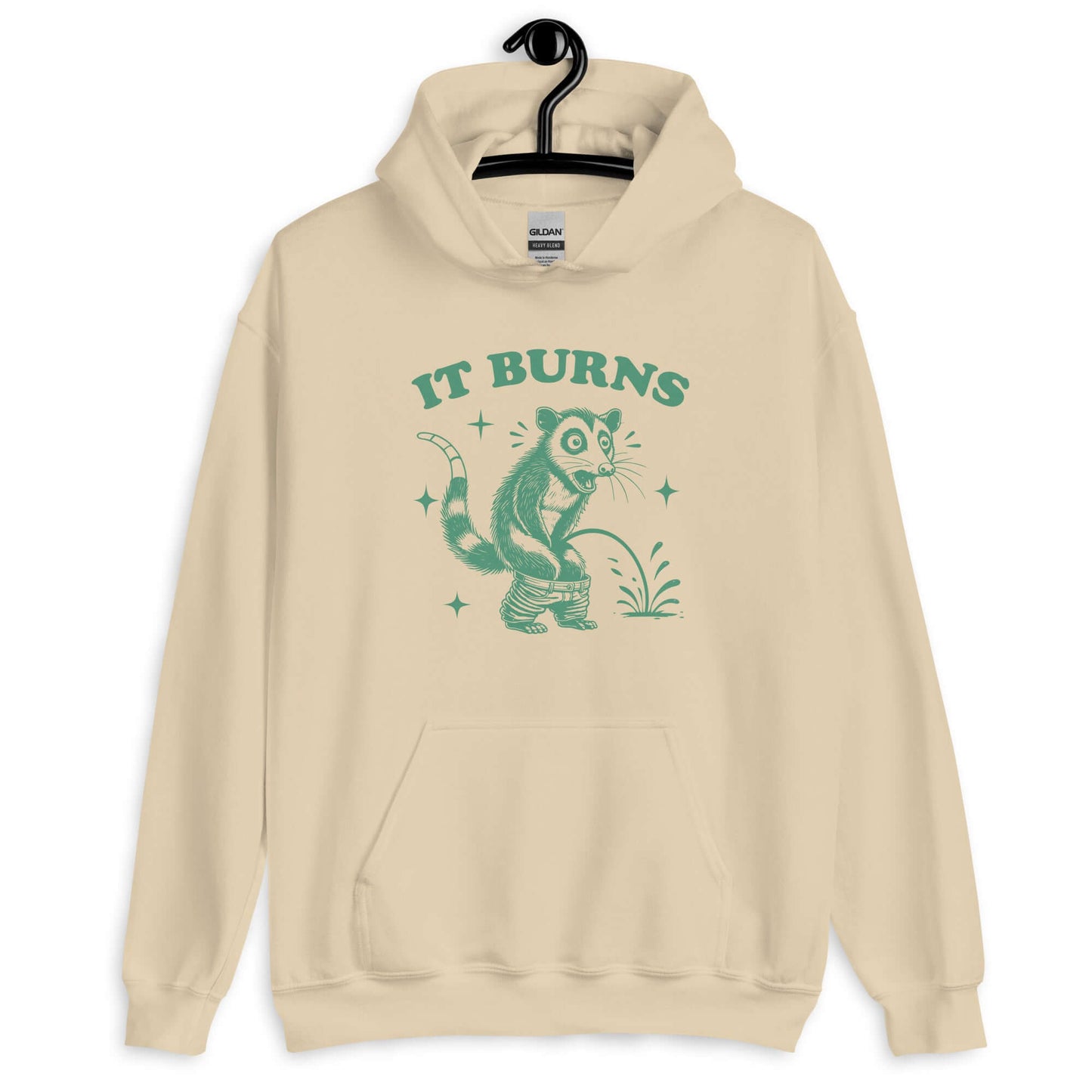 Sand color hoodie sweatshirt with an image of an opossum peeing. The words It burns are printed above.