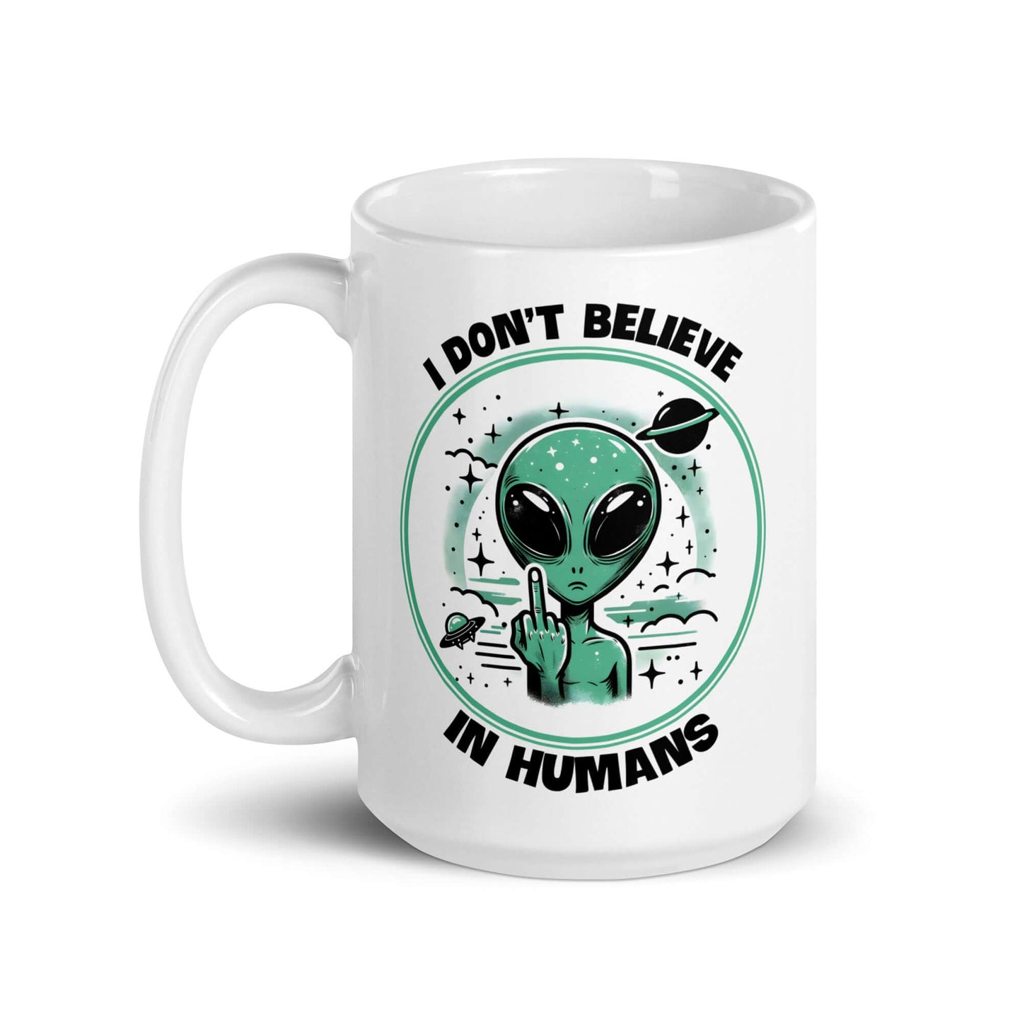 White ceramic mug with an image of an alien flipping the middle finger. The words I don't believe in humans are printed around the image. The graphics are printed on both sides of the mug.