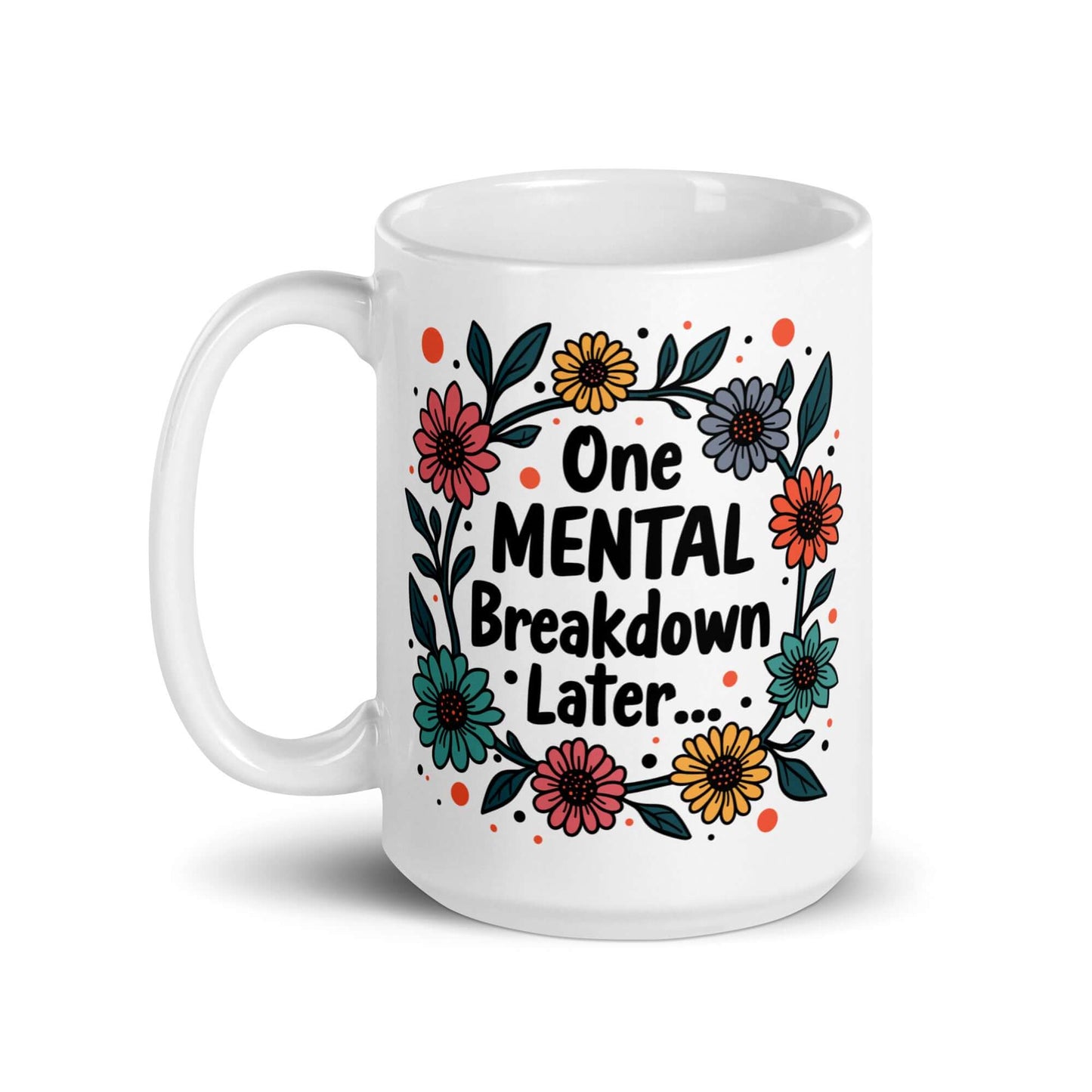White ceramic mug with a multi color floral wreath design printed on it. The words One mental breakdown later are printed in the center of the wreath. The graphics are printed on both sides of the mug.