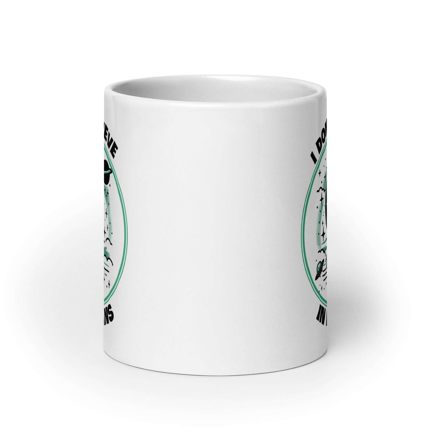 White ceramic mug with an image of an alien flipping the middle finger. The words I don't believe in humans are printed around the image. The graphics are printed on both sides of the mug.