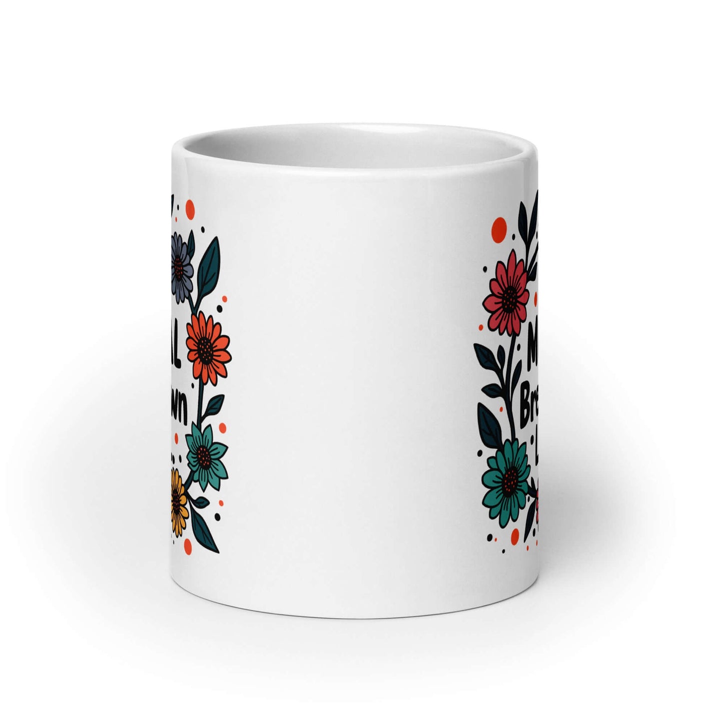 White ceramic mug with a multi color floral wreath design printed on it. The words One mental breakdown later are printed in the center of the wreath. The graphics are printed on both sides of the mug.