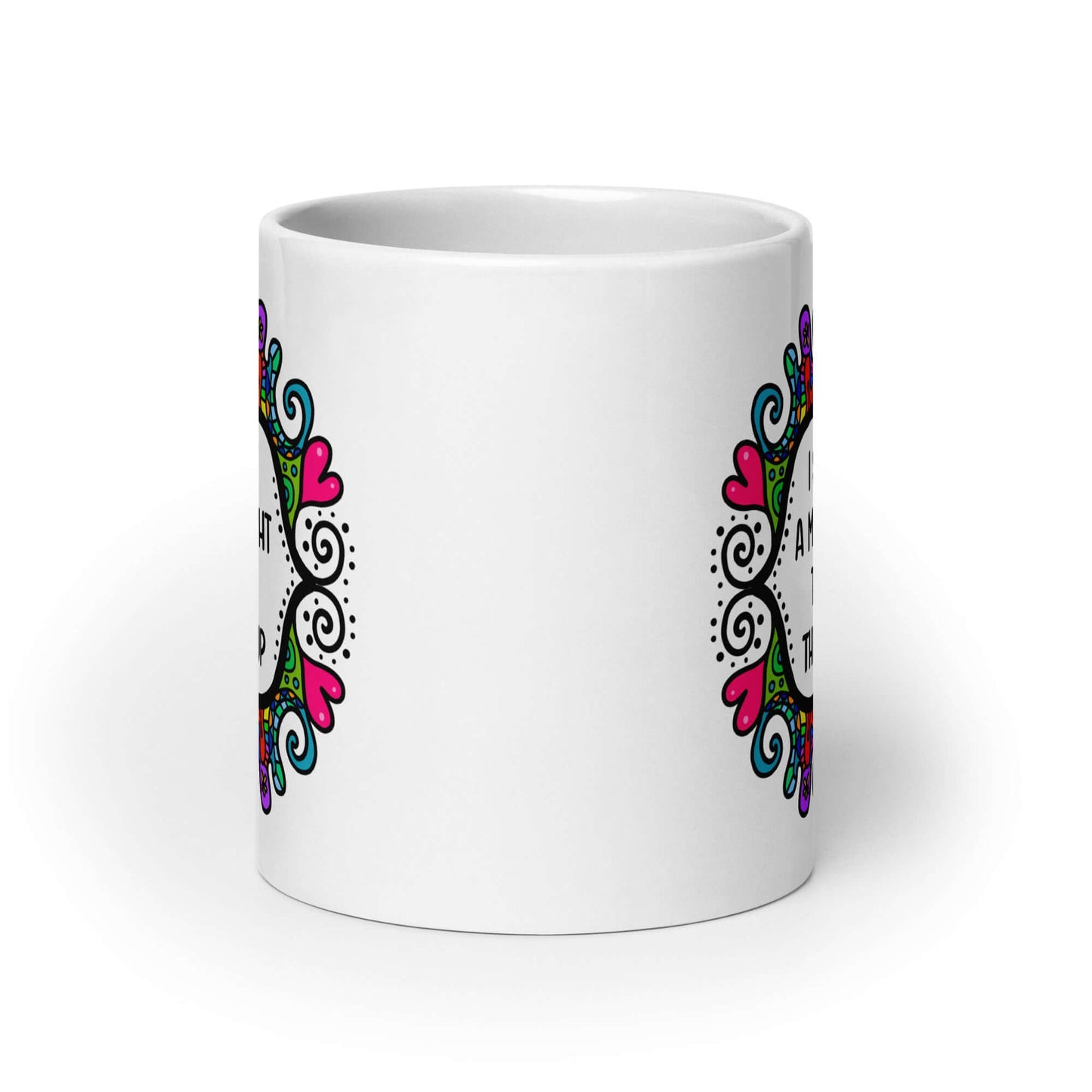 White ceramic mug with a colorful doodle graphic and the words I support a man's right to shut the hell up. The design is printed on both sides of the mug.