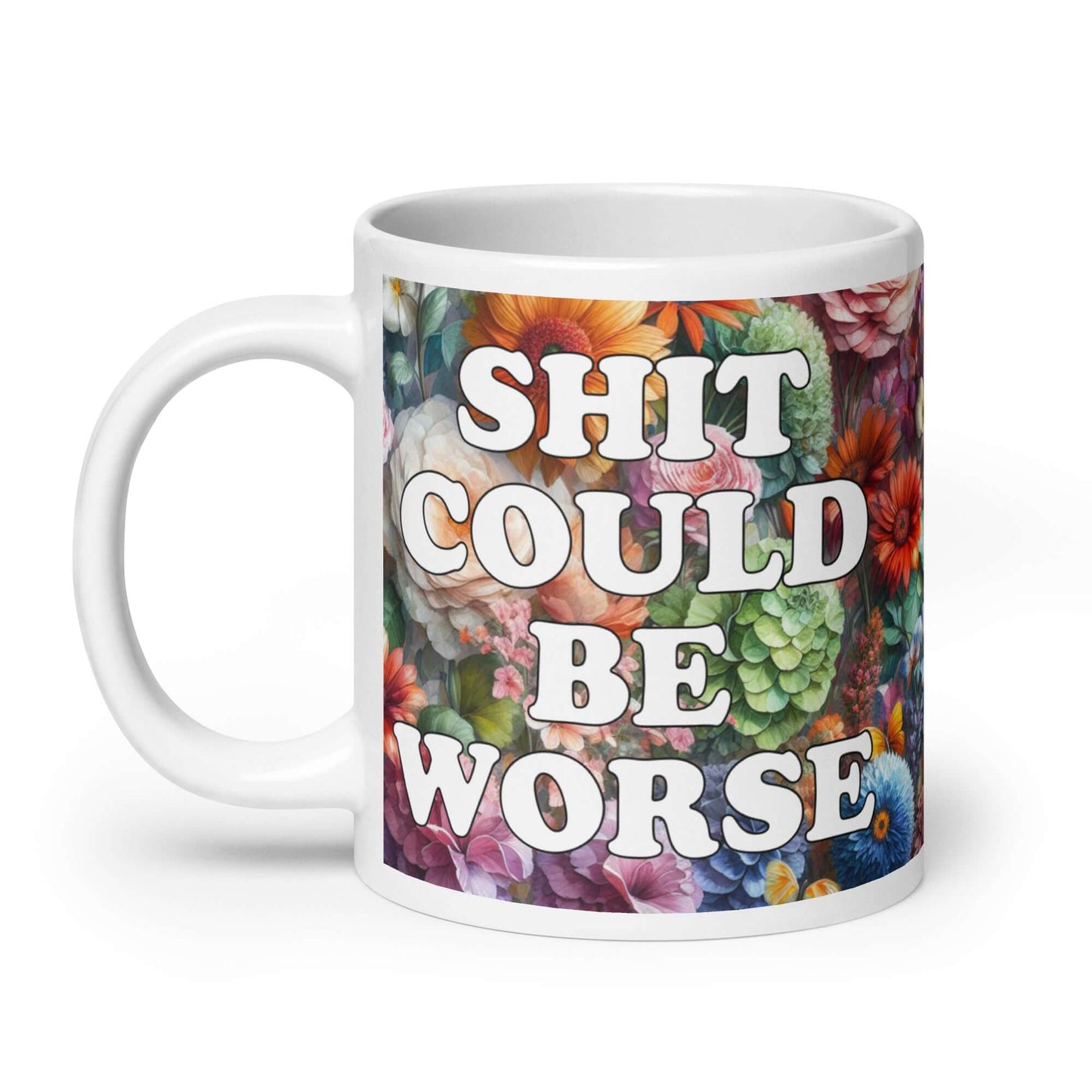 White ceramic mug floral background and the words Shit could be worse printed on both sides.