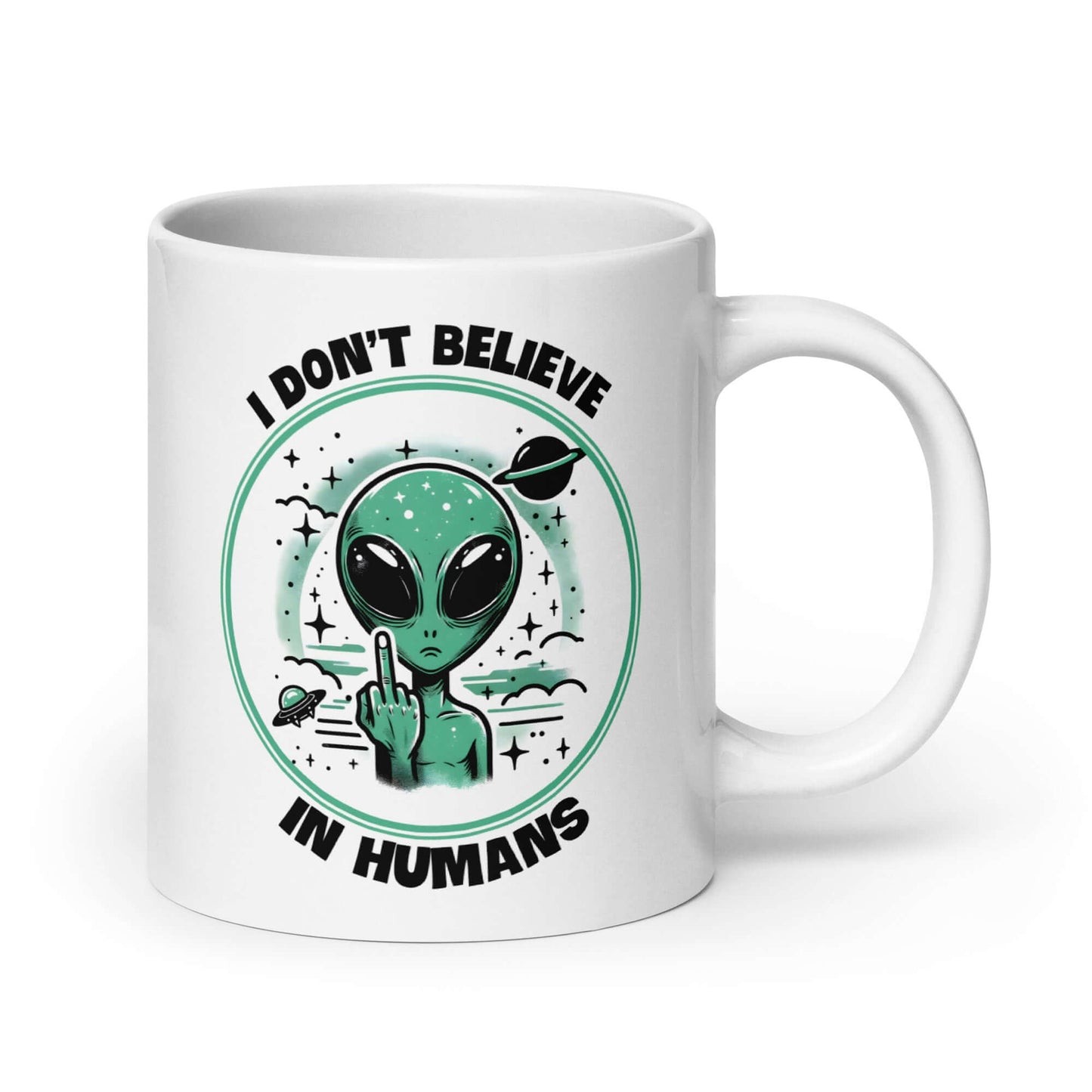 White ceramic mug with an image of an alien flipping the middle finger. The words I don't believe in humans are printed around the image. The graphics are printed on both sides of the mug.
