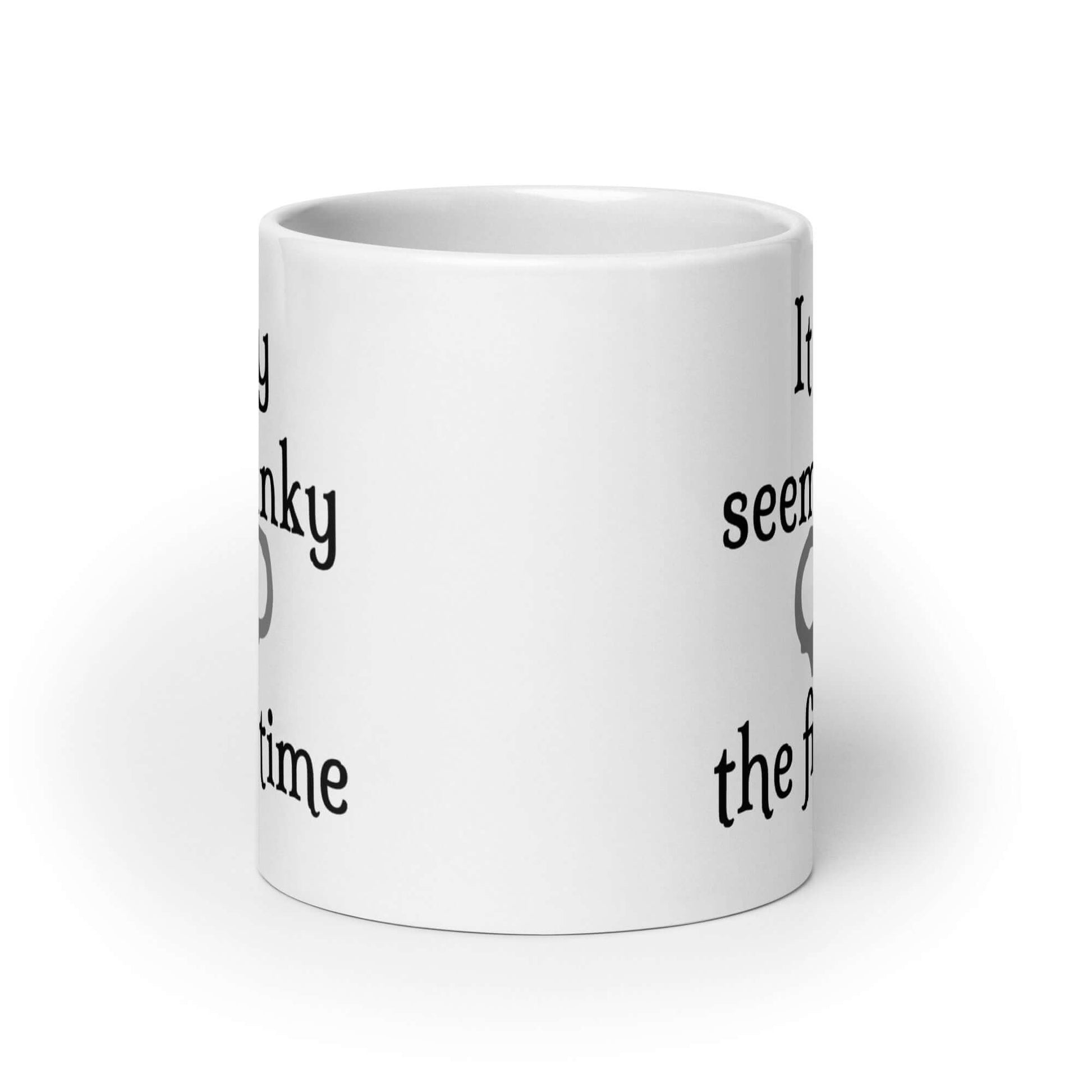 White ceramic coffee mug with the phrase It only seems kinky the first time printed on both sides of the mug. There is an image of handcuffs with the text.