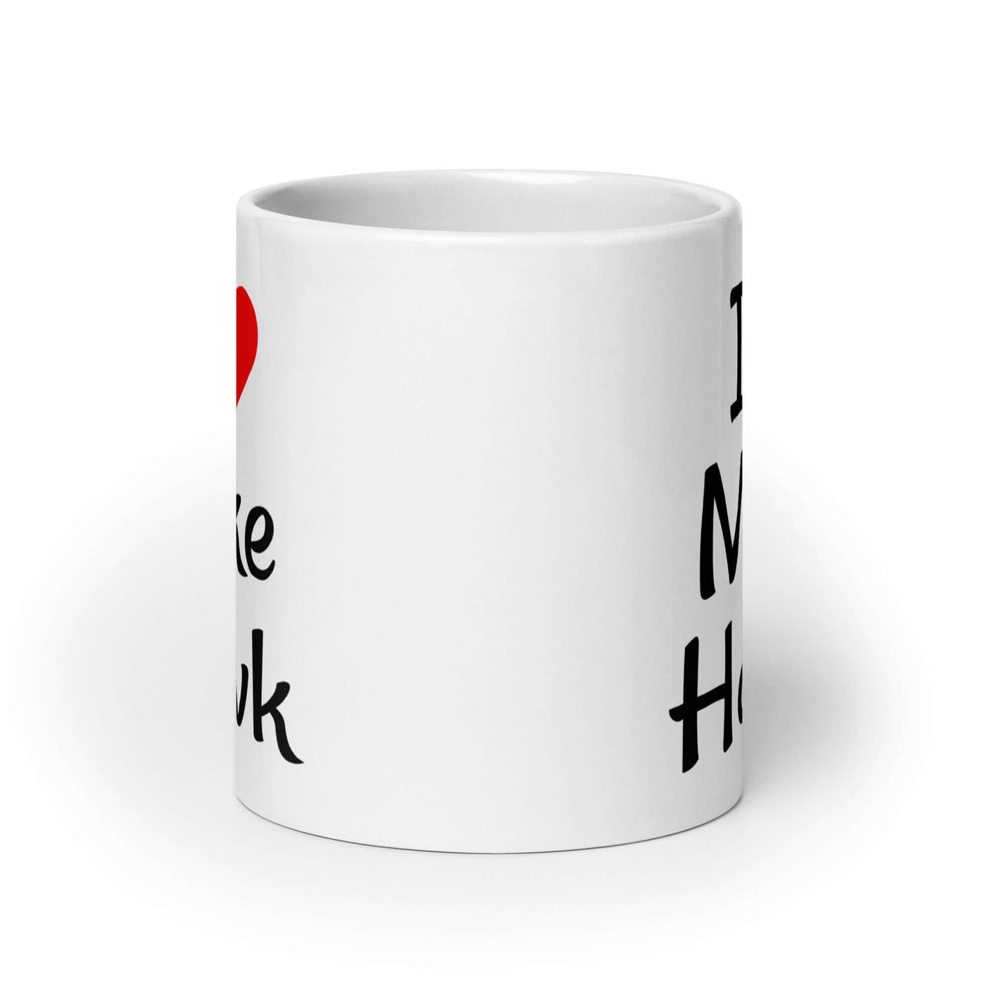 White ceramic coffee mug with the pun I heart Mike Hawk printed on both sides of the mug.
