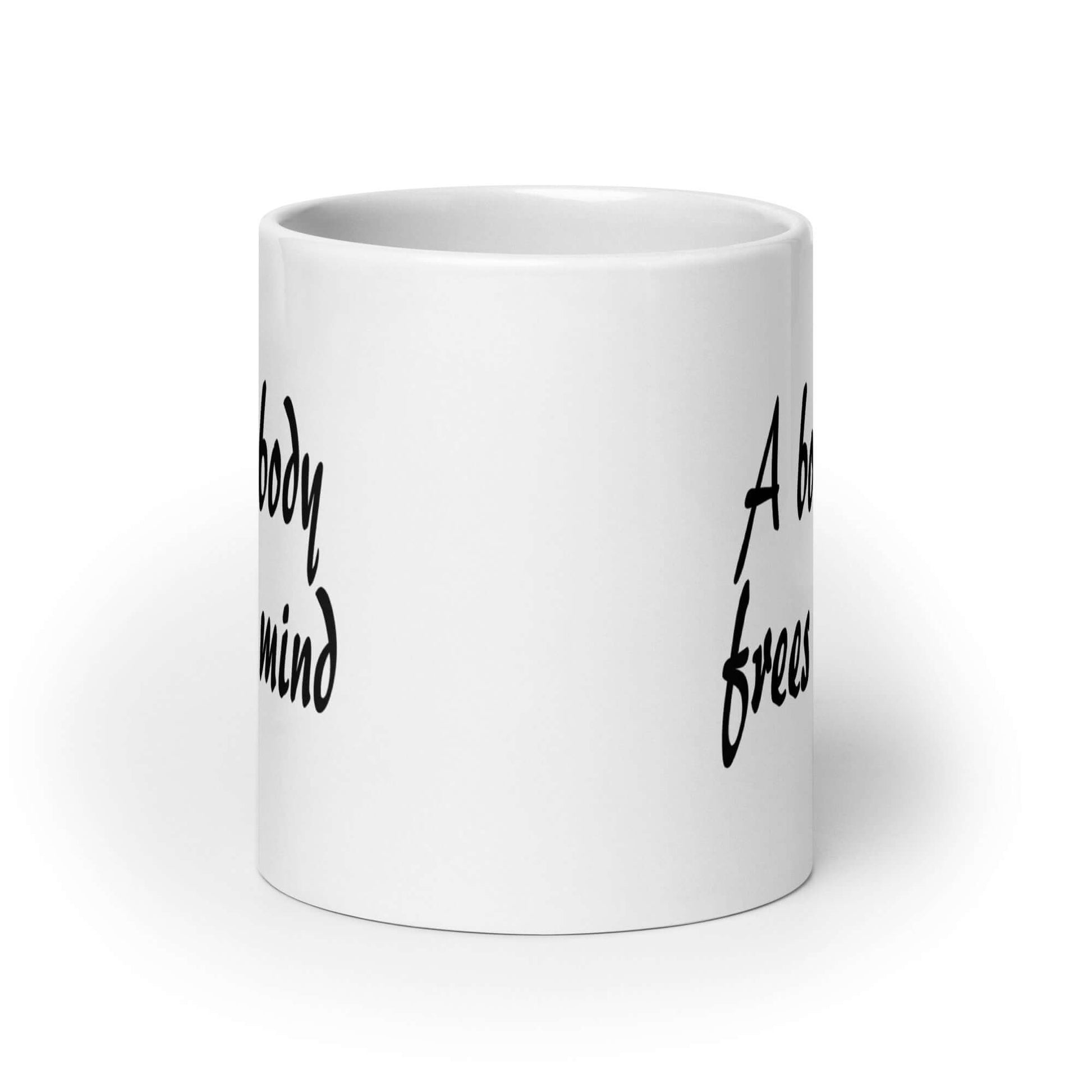 White ceramic coffee mug with the phrase A bound body frees the mind printed on both sides of the mug.