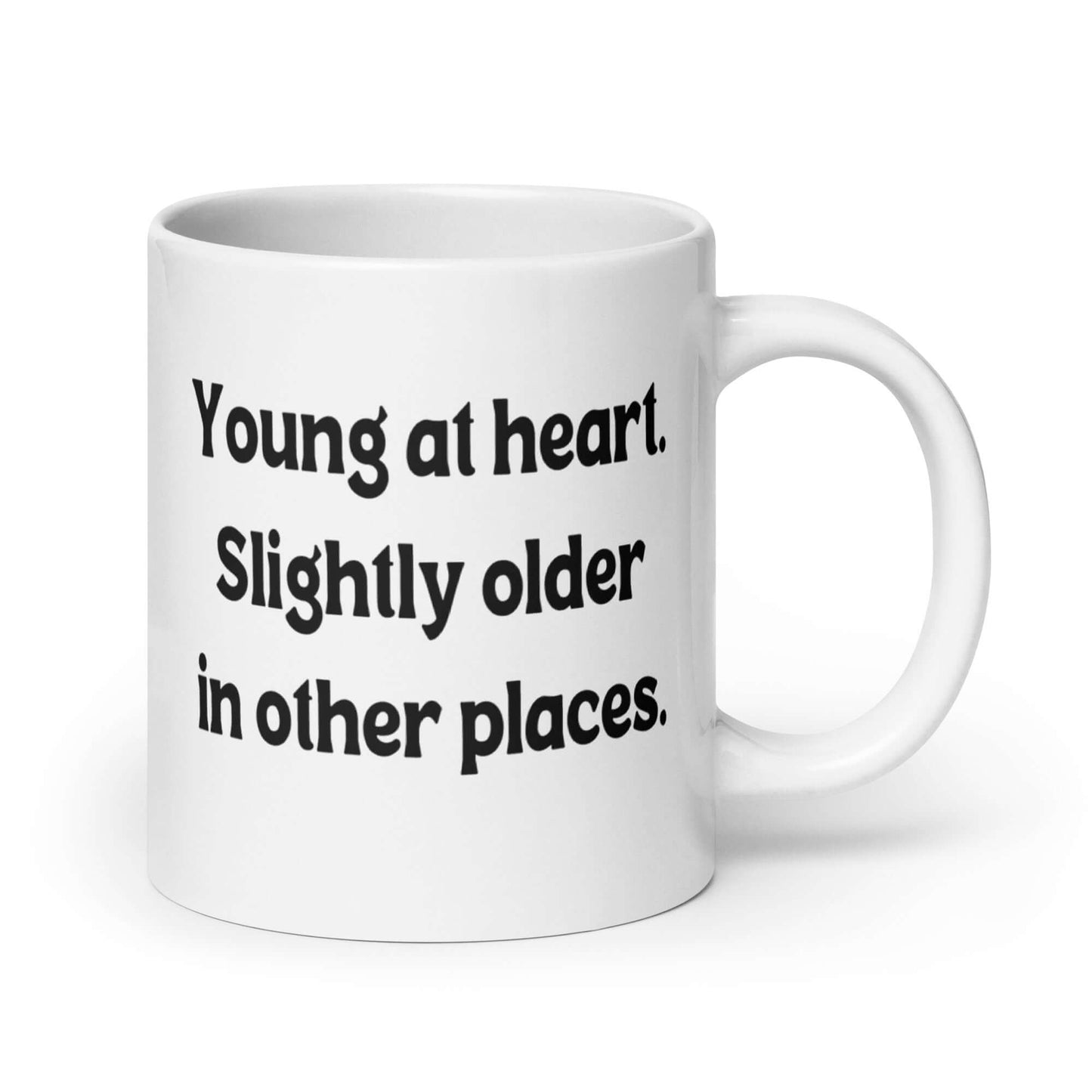 White ceramic mug with the words Young at heart, slightly older in other places printed on both sides.