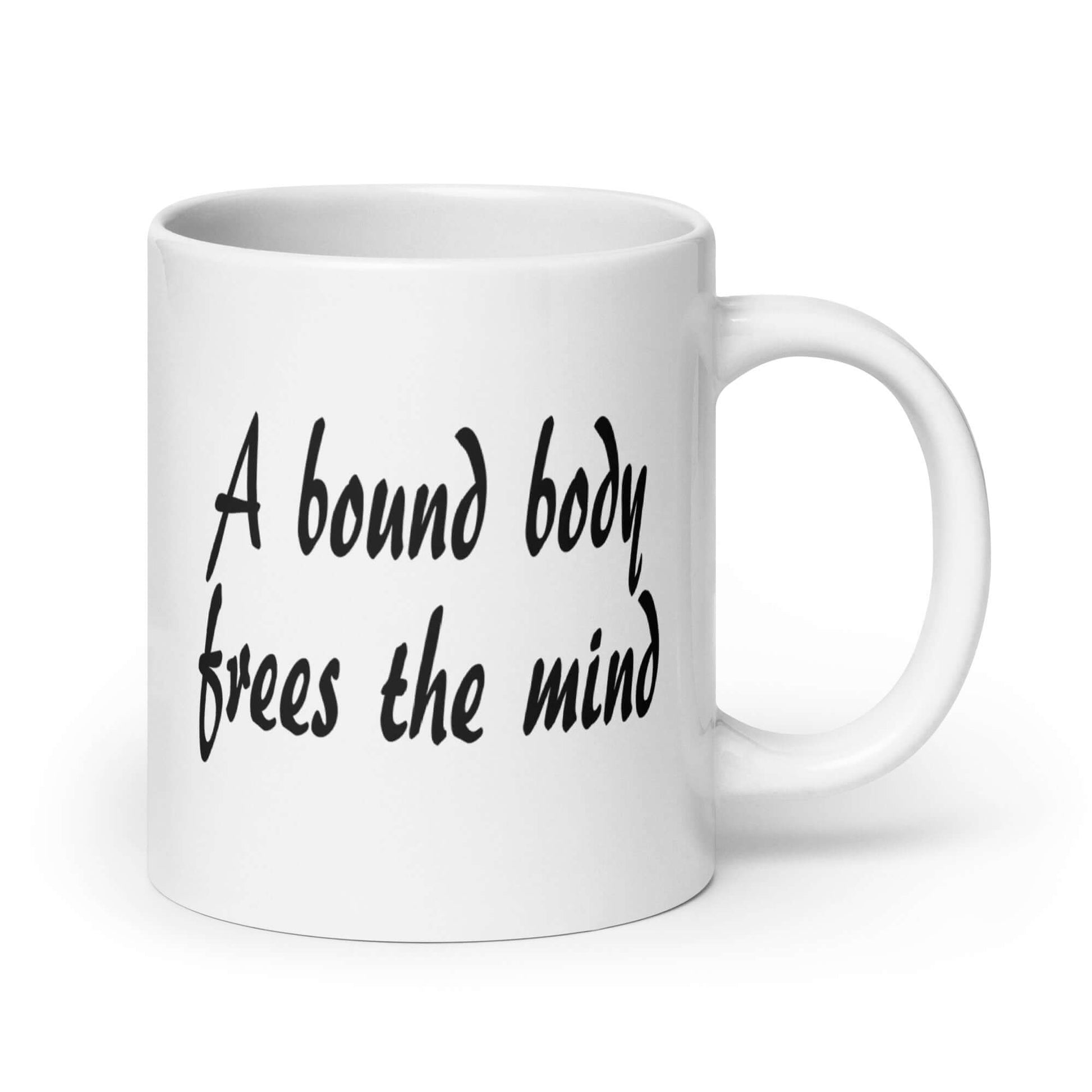 White ceramic coffee mug with the phrase A bound body frees the mind printed on both sides of the mug.