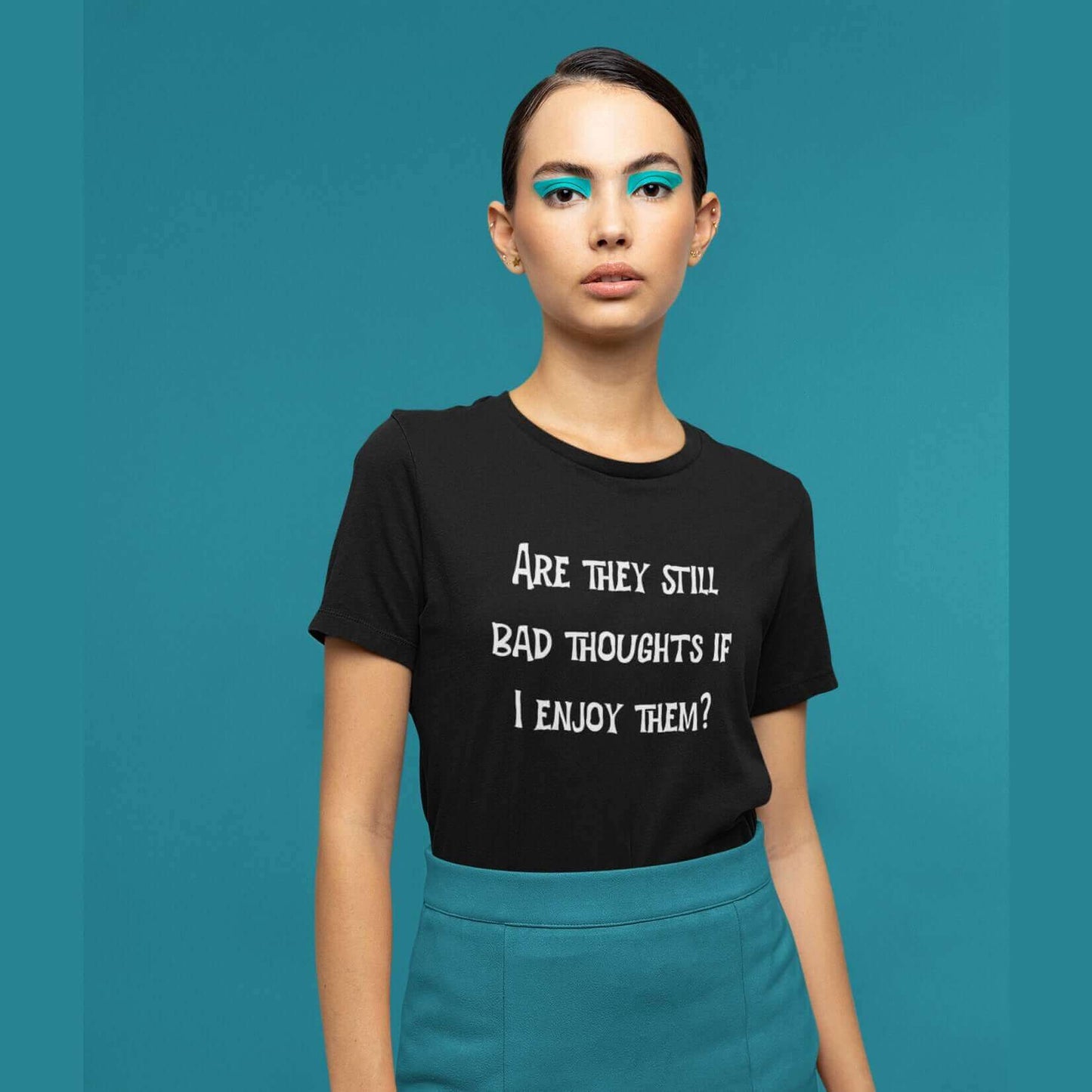 Woman wearing black t-shirt with the phrase Are they still bad thoughts if I enjoy them question mark printed on the front.